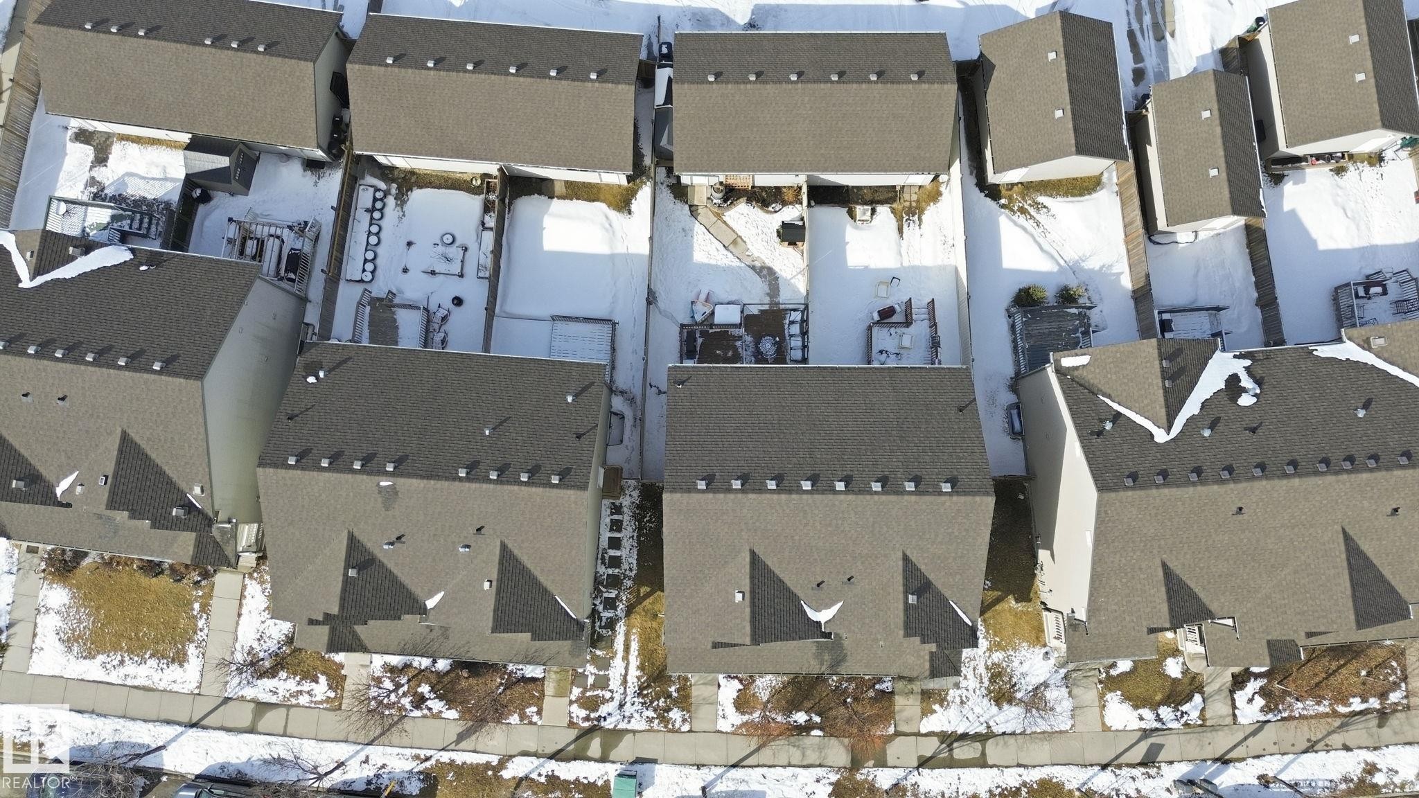 Aerial view of the property and surrounding residences, featuring dark shingled roofs and a sidewalk - 430 Watt Boulevard, Edmonton, AB -