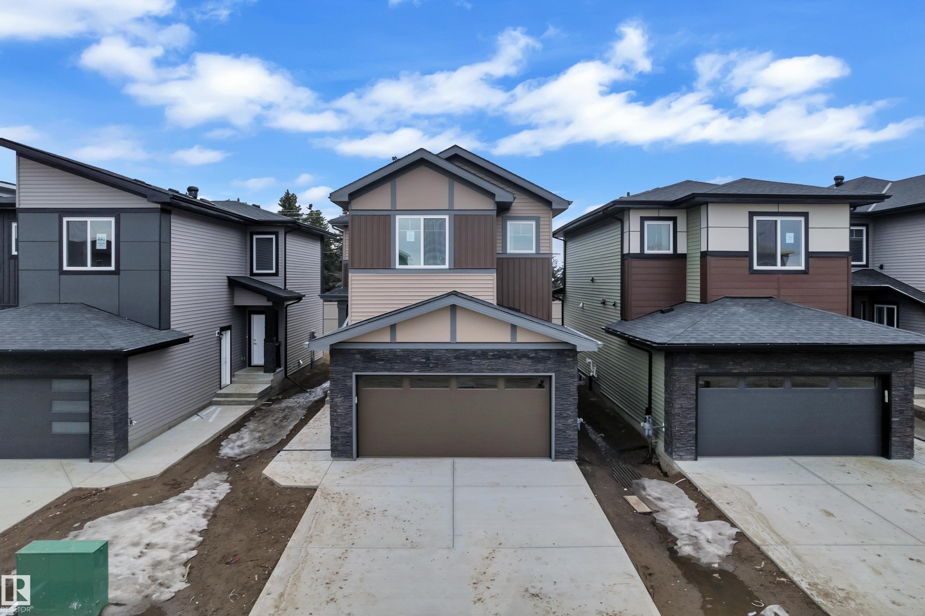This property features a modern exterior with a two-car garage, concrete driveway, and multi-toned siding - 237 Linden Loop, Leduc, AB - Outdoor With Facade