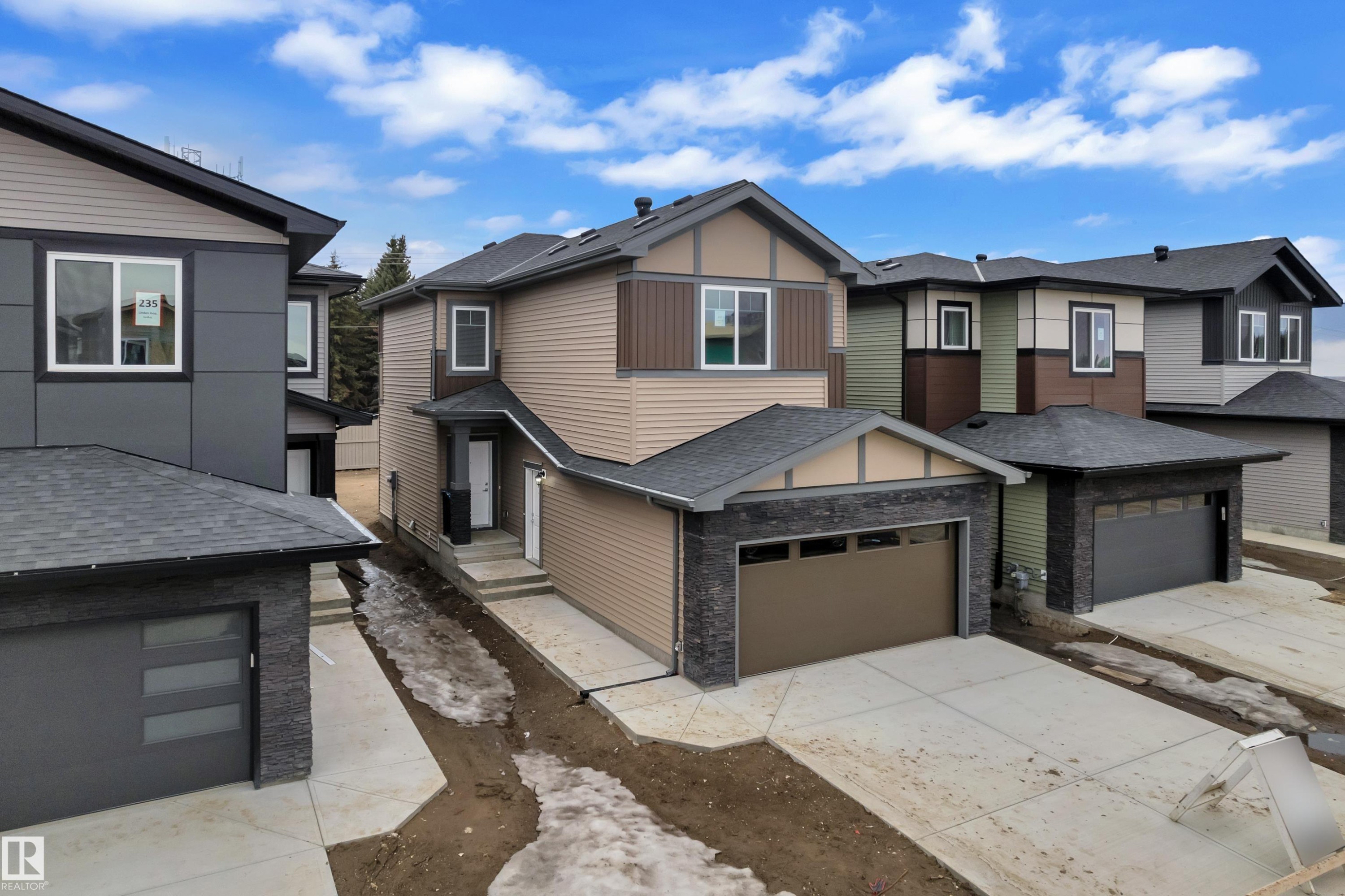 The property features a two-story design with a brown facade and dark stone accents - 237 Linden Loop, Leduc, AB - Outdoor
