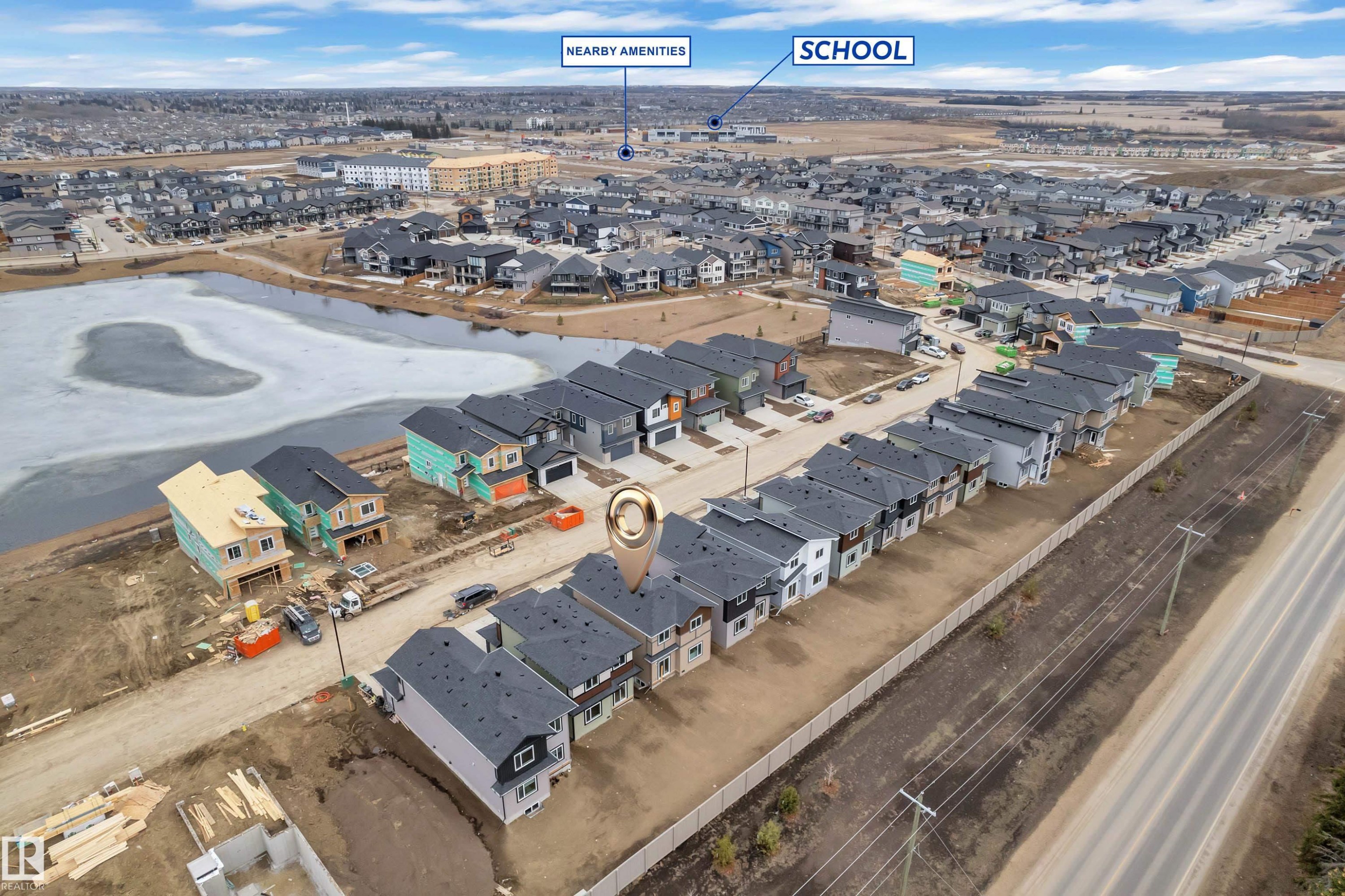 Aerial view of the property and its surrounding area, featuring a street with houses and a nearby body of water - 237 Linden Loop, Leduc, AB - Outdoor With View
