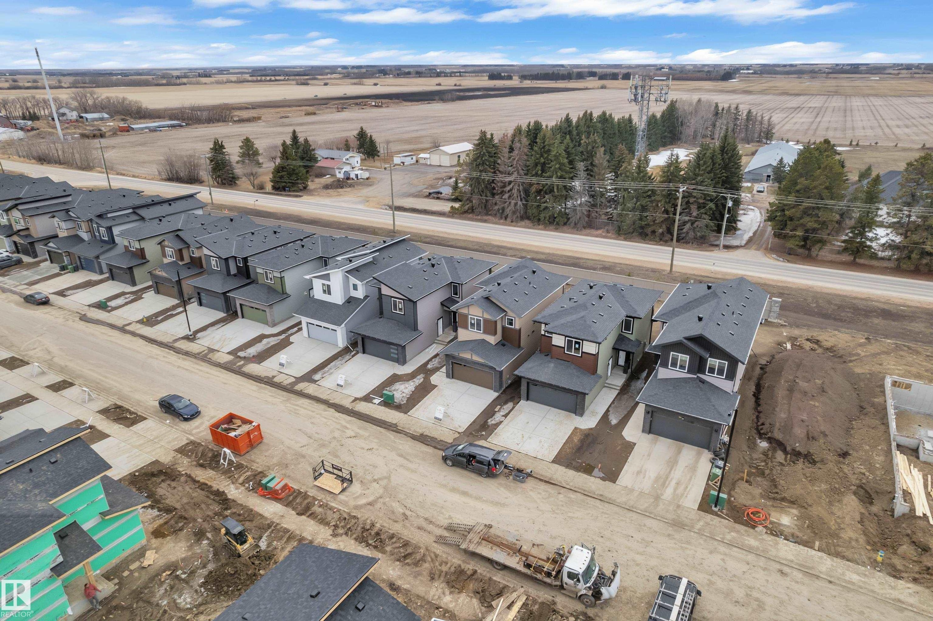 The property is part of a newly developed street featuring modern homes with dark roofs and light-colored siding - 237 Linden Loop, Leduc, AB - Outdoor With View