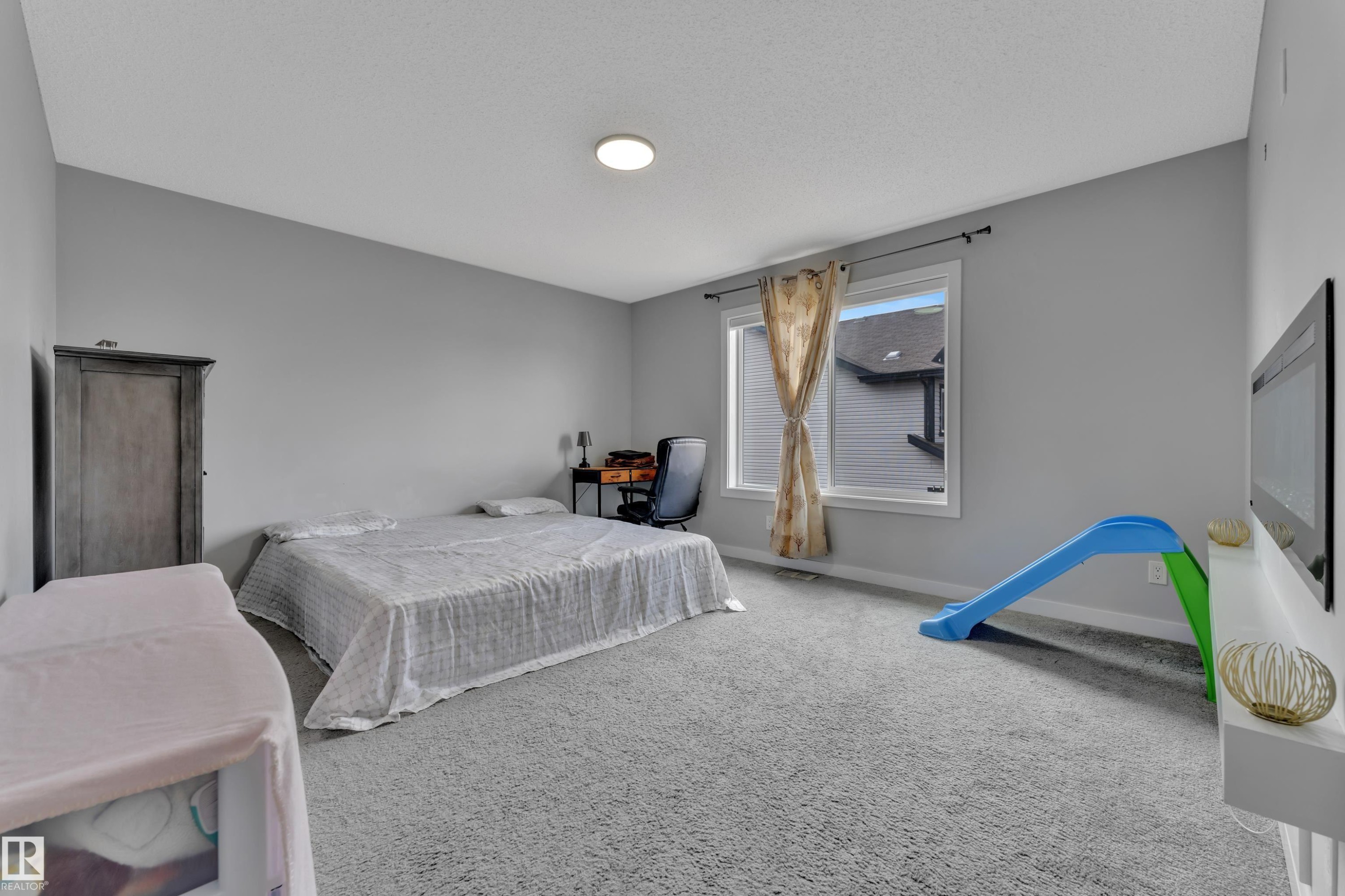 This room features light grey walls and grey carpet, creating a neutral aesthetic - 1452 30 Street, Edmonton, AB - Indoor Photo Showing Bedroom