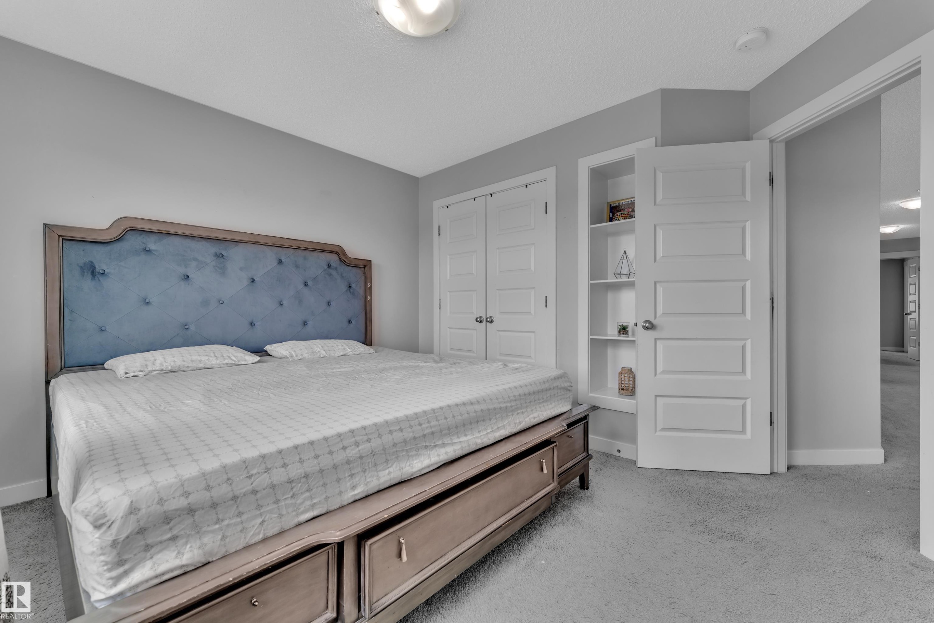 Bedroom featuring light grey walls, light grey carpet, and a white ceiling with a flush-mount light fixture - 1452 30 Street, Edmonton, AB - Indoor Photo Showing Bedroom