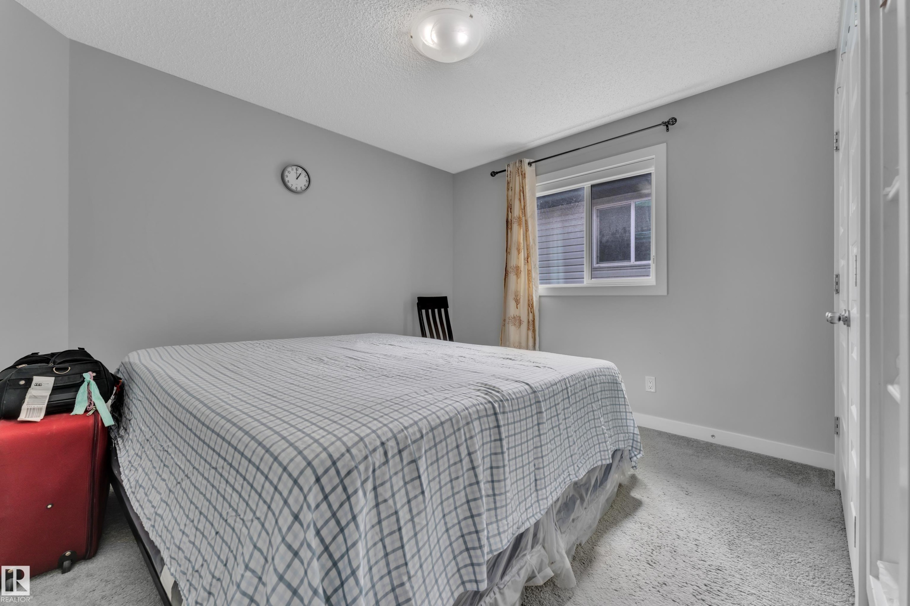 This room features light grey walls, light grey carpet, and a window with curtains - 1452 30 Street, Edmonton, AB - Indoor Photo Showing Bedroom