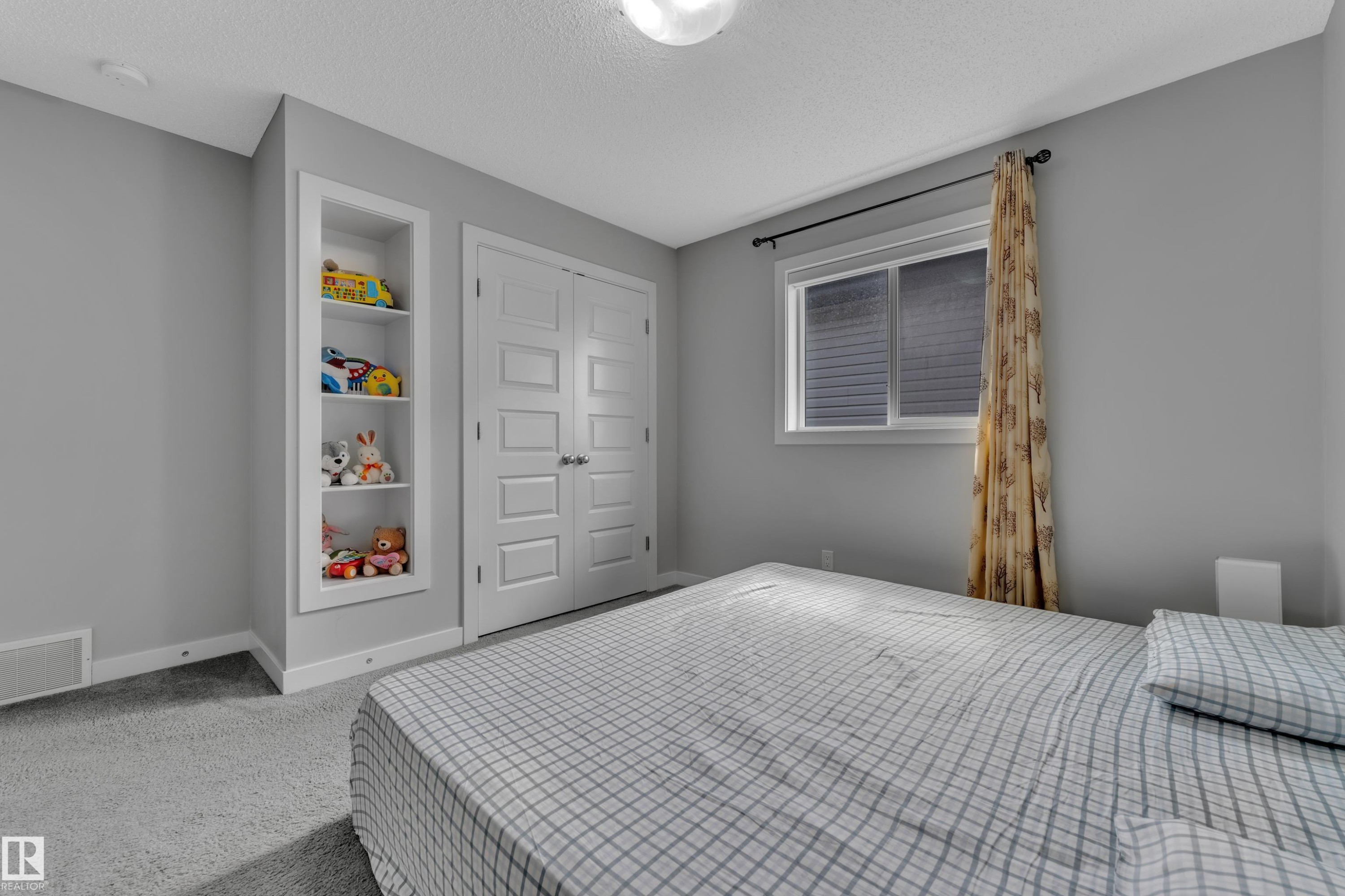 This room features soft gray wall paint, light gray carpeting, and a window with blinds and a curtain rod - 1452 30 Street, Edmonton, AB - Indoor Photo Showing Bedroom