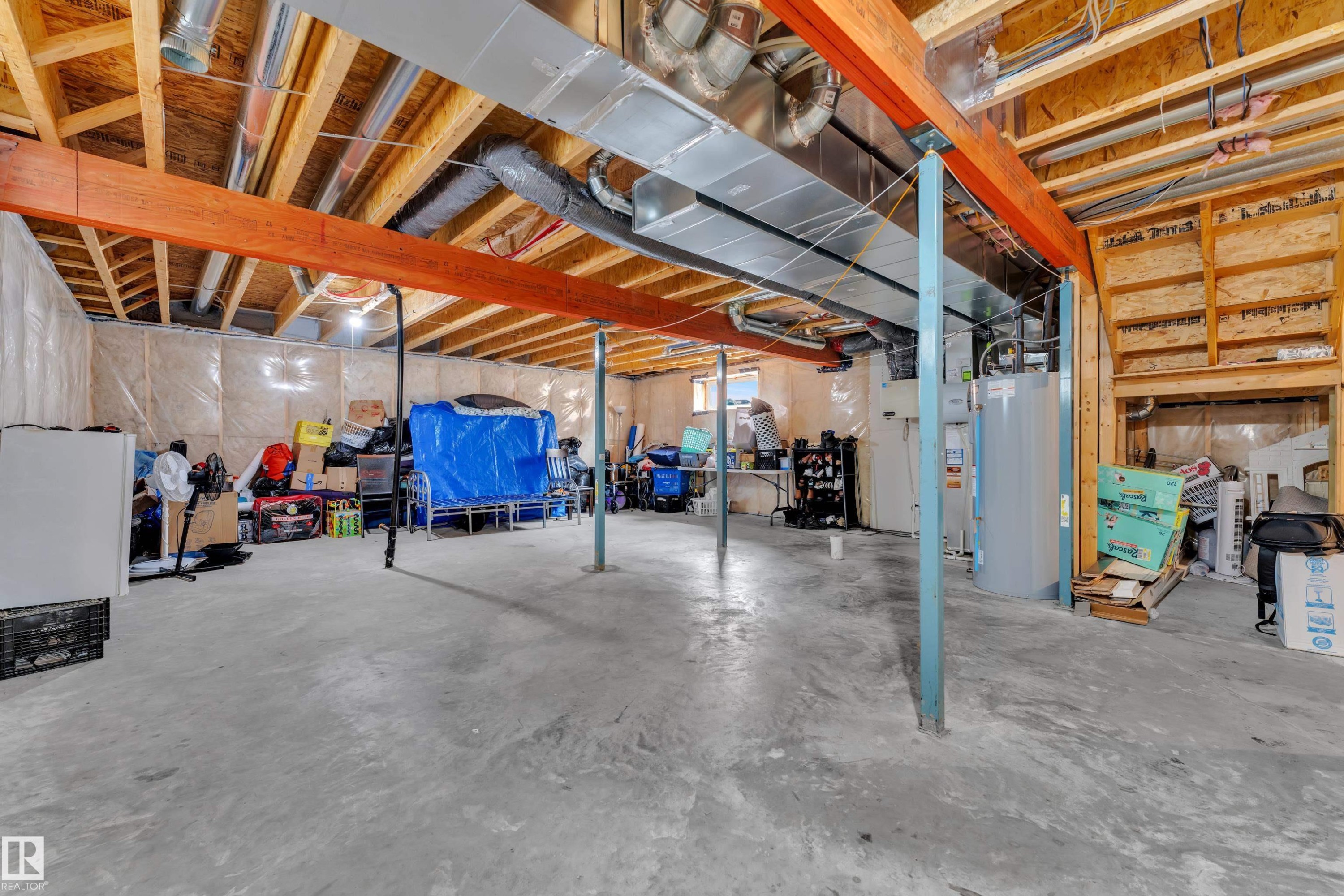 The property features an unfinished basement with exposed wooden beams, a concrete floor, and visible insulation along the walls - 1452 30 Street, Edmonton, AB - Indoor Photo Showing Basement