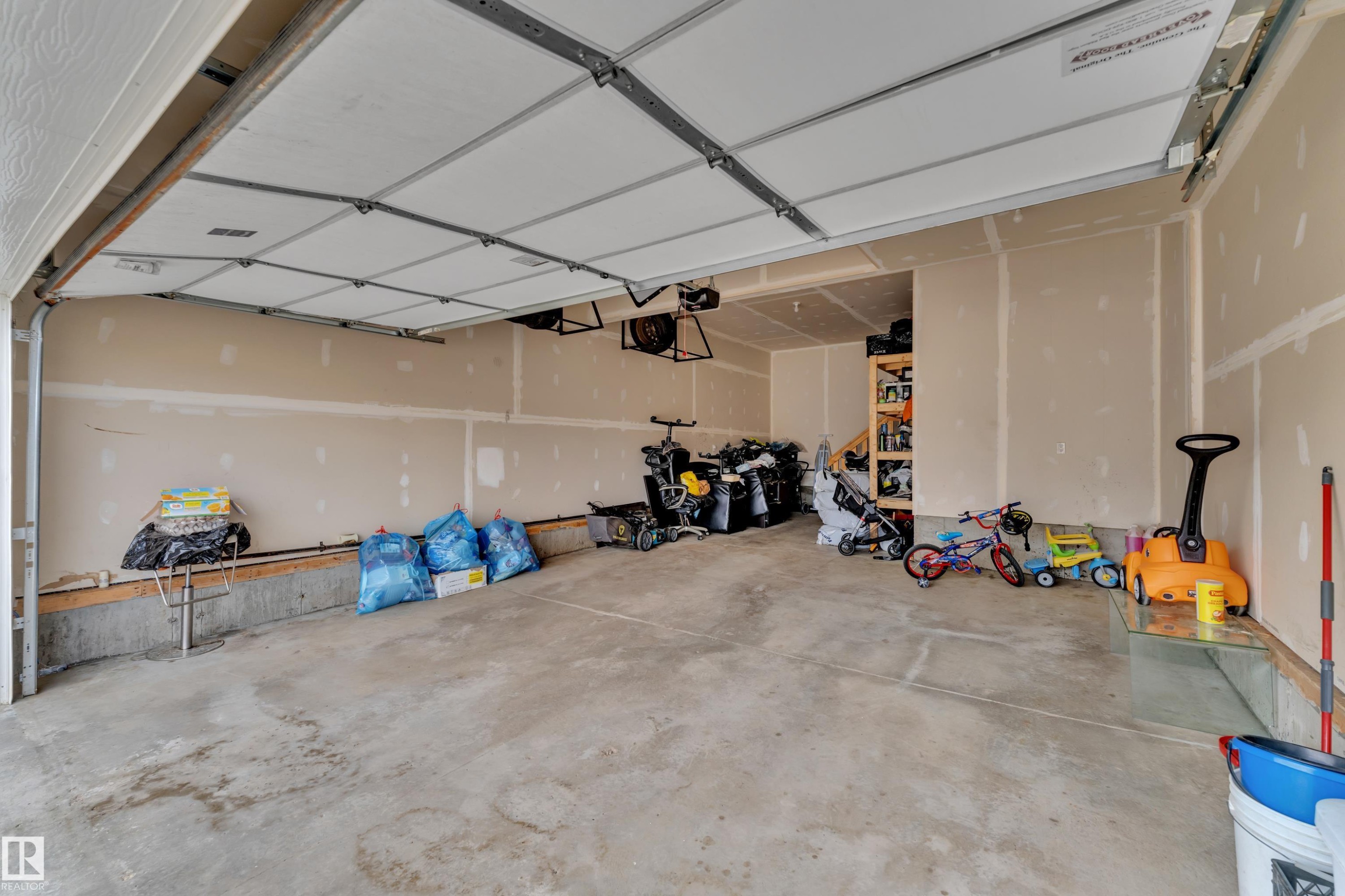 The property features a garage with a concrete floor and an overhead garage door - 1452 30 Street, Edmonton, AB - Indoor Photo Showing Garage