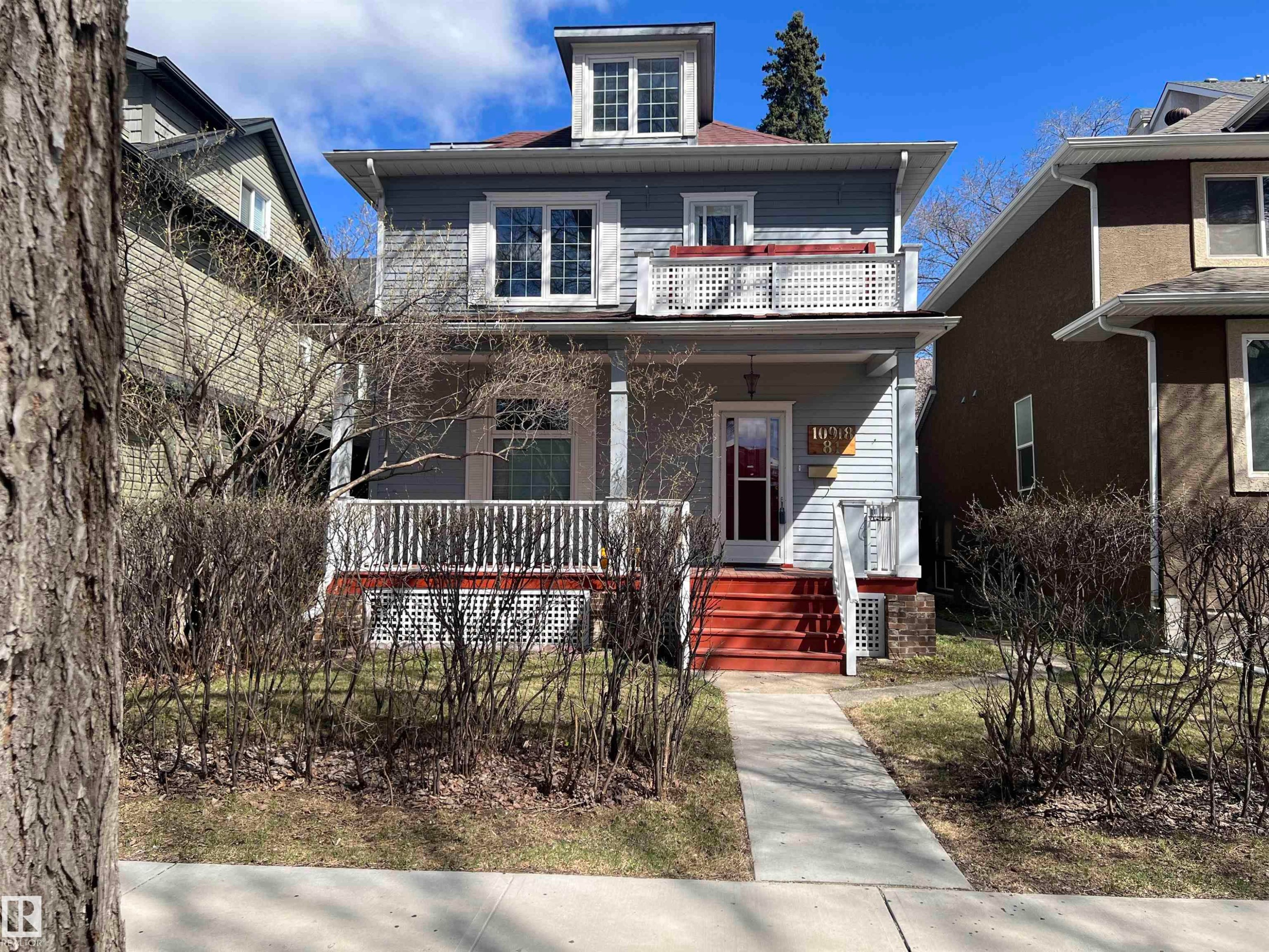 Two-story residence featuring light gray siding with white trim accents and a dormer window - 10918 81 Avenue, Edmonton, AB - Outdoor With Balcony