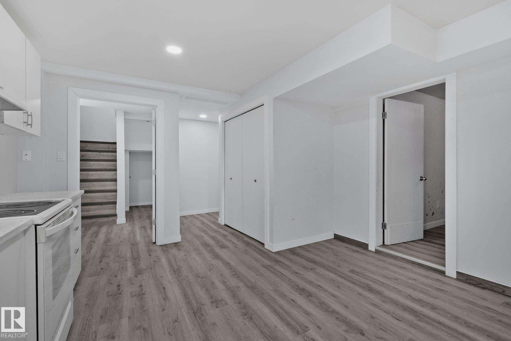 This versatile room features light-toned flooring, white walls, and recessed lighting - 12002 37 Street, Edmonton, AB - Indoor Photo Showing Kitchen