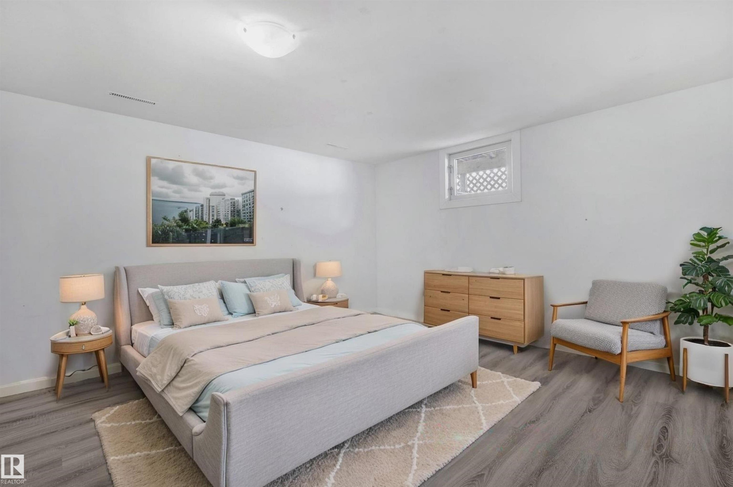This room features light grey flooring and white walls, creating a bright and open atmosphere - 12002 37 Street, Edmonton, AB - Indoor Photo Showing Bedroom