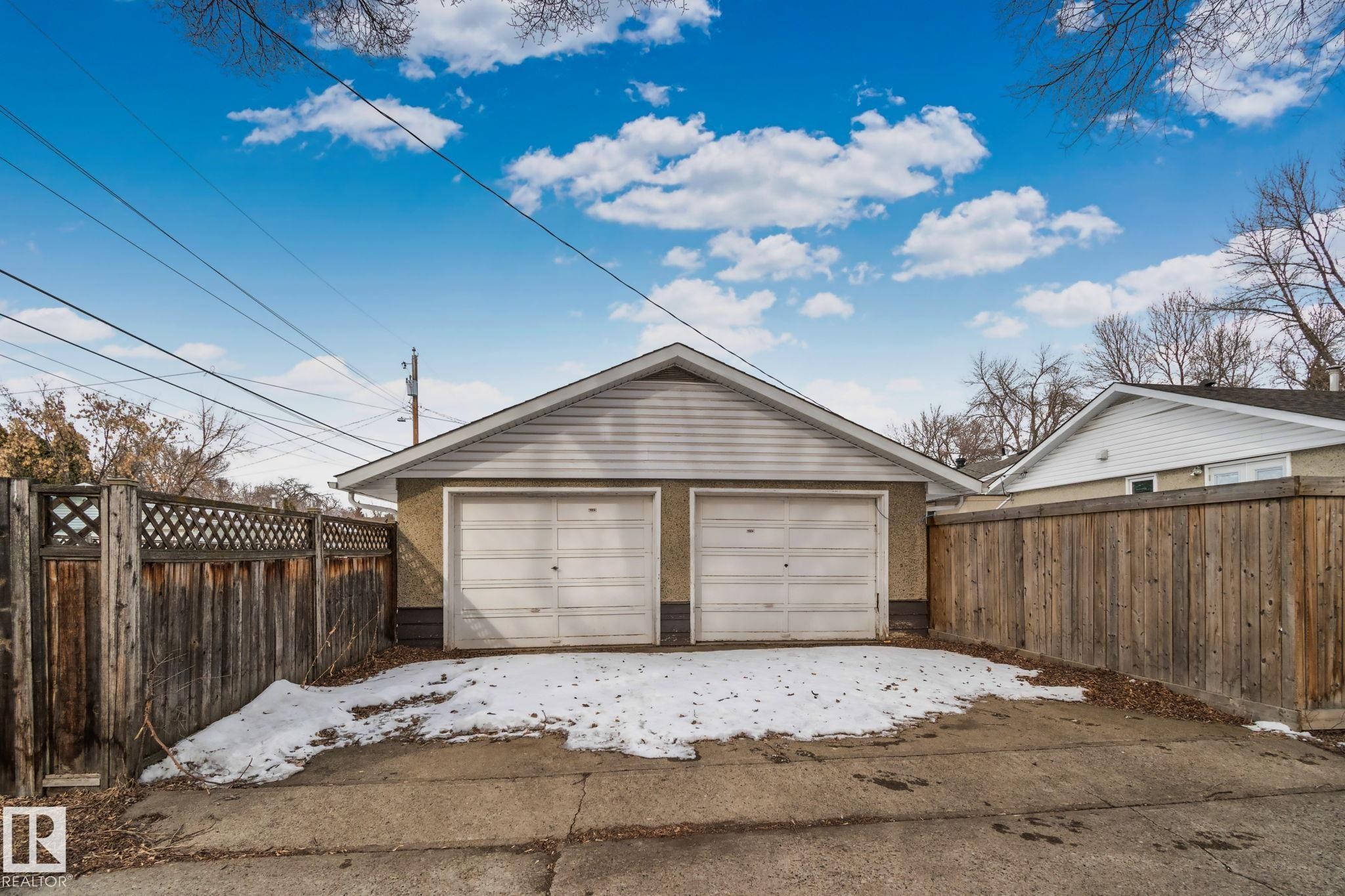 Detached garage with two garage doors and a gabled roof - 12002 37 Street, Edmonton, AB - Outdoor