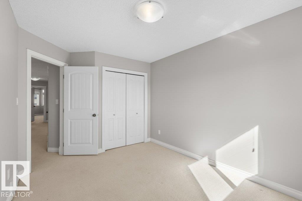 The room features light-colored walls and carpeted flooring - 16419 53 Street, Edmonton, AB - Indoor Photo Showing Other Room