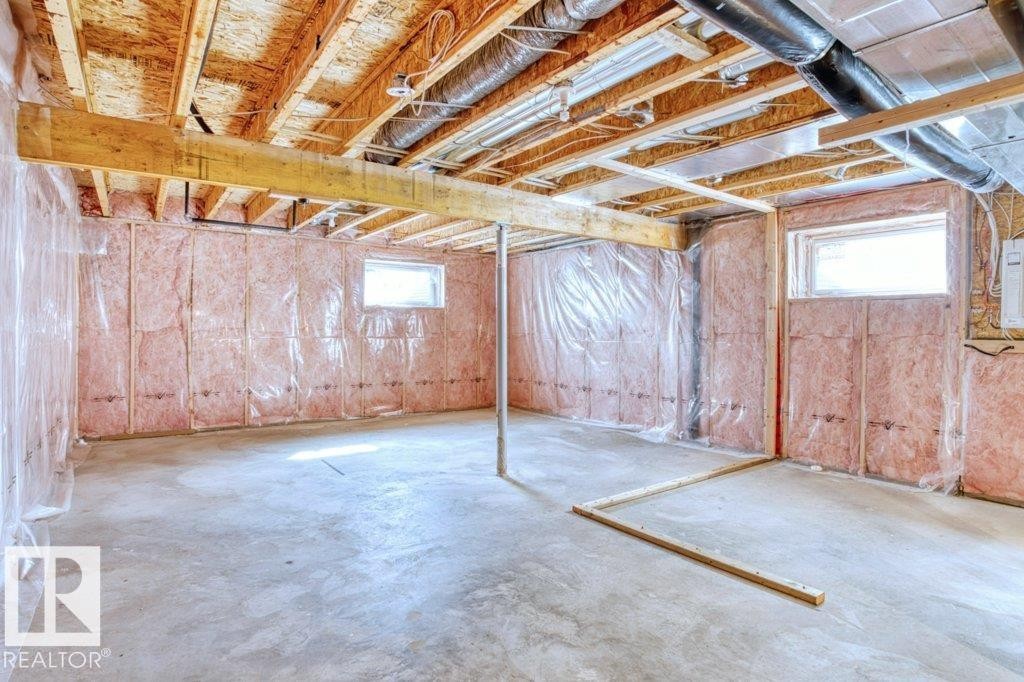 The property features a spacious unfinished basement with concrete flooring and exposed wooden joists - 16419 53 Street, Edmonton, AB - Indoor Photo Showing Basement