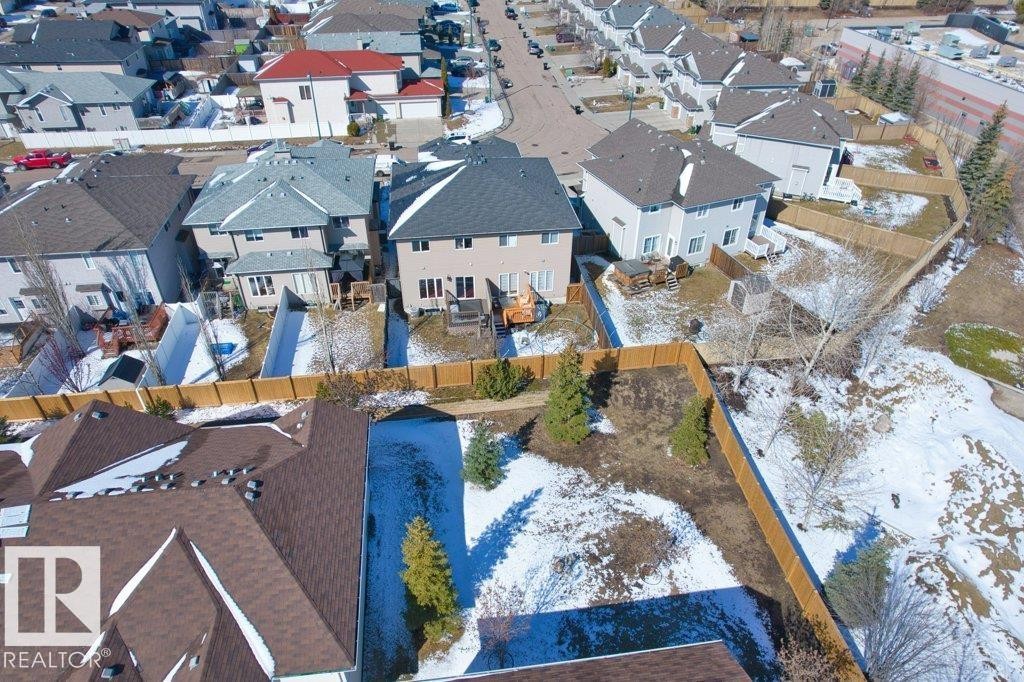 Aerial view showcasing the property's exterior, including a fenced yard, and a paved driveway - 16419 53 Street, Edmonton, AB - Outdoor With View