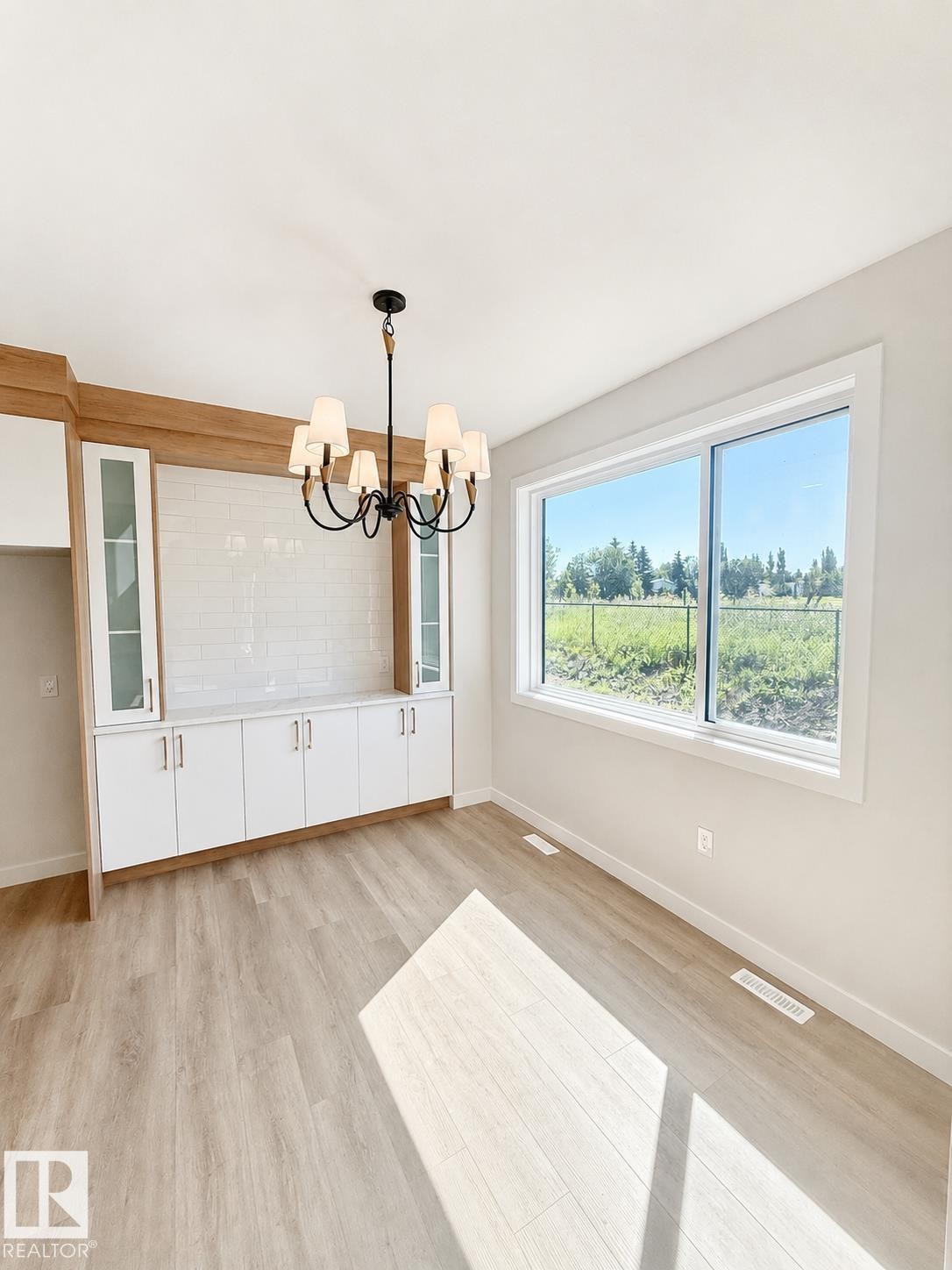 Built-in cabinetry with glass-front uppers and white subway tile backsplash - 22 Meadowgrove Landing, Spruce Grove, AB - Indoor Photo Showing Other Room