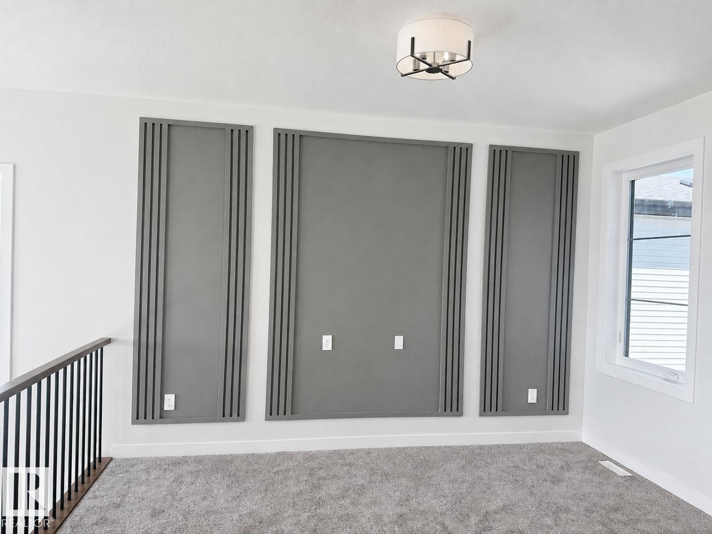 White walls with decorative paneling and light gray carpeting - 22 Meadowgrove Landing, Spruce Grove, AB - Indoor Photo Showing Other Room