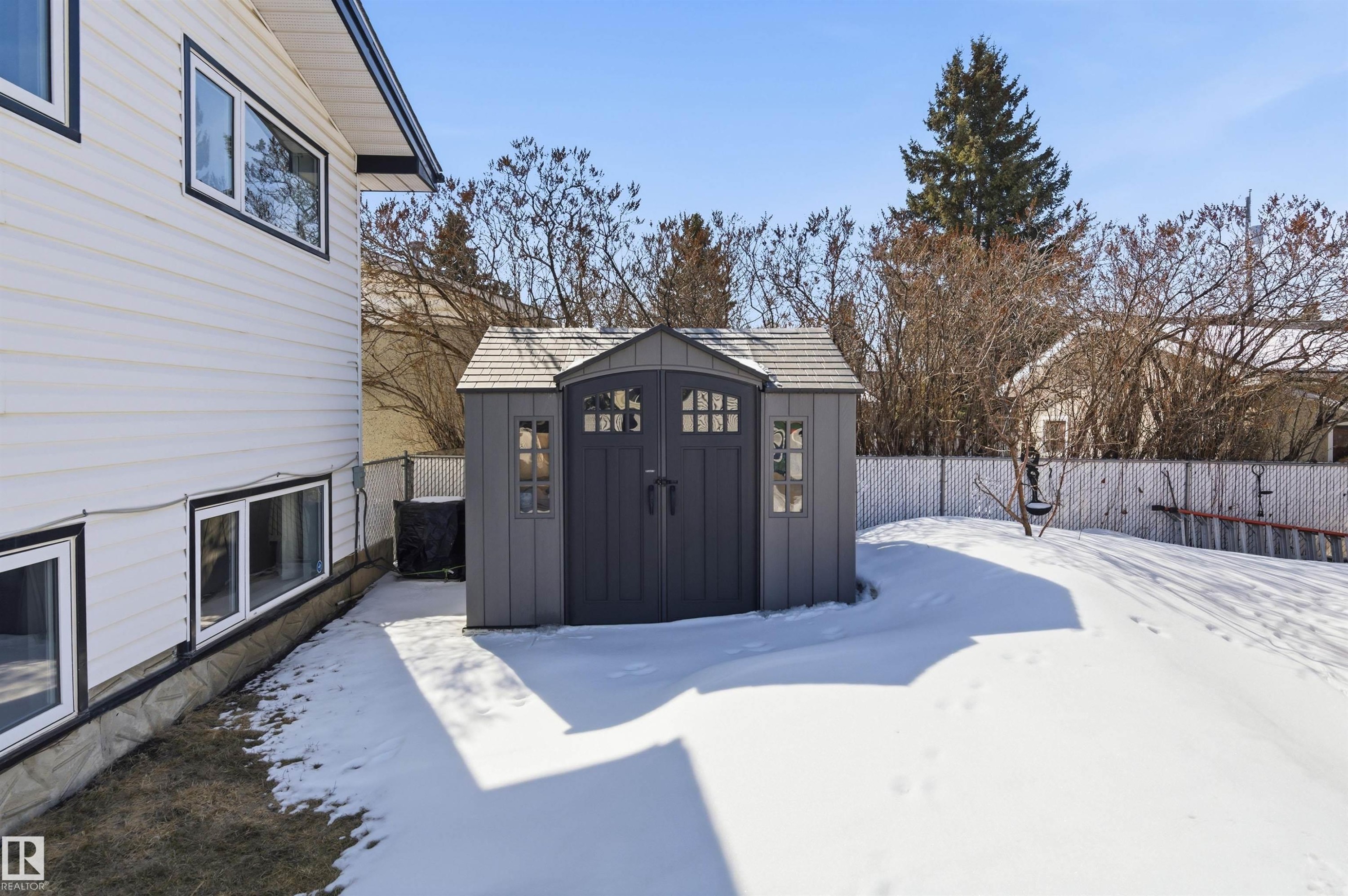 The property includes a gray shed with a shingled roof, offering outdoor storage - 12904 95 Street, Edmonton, AB - Outdoor With Exterior