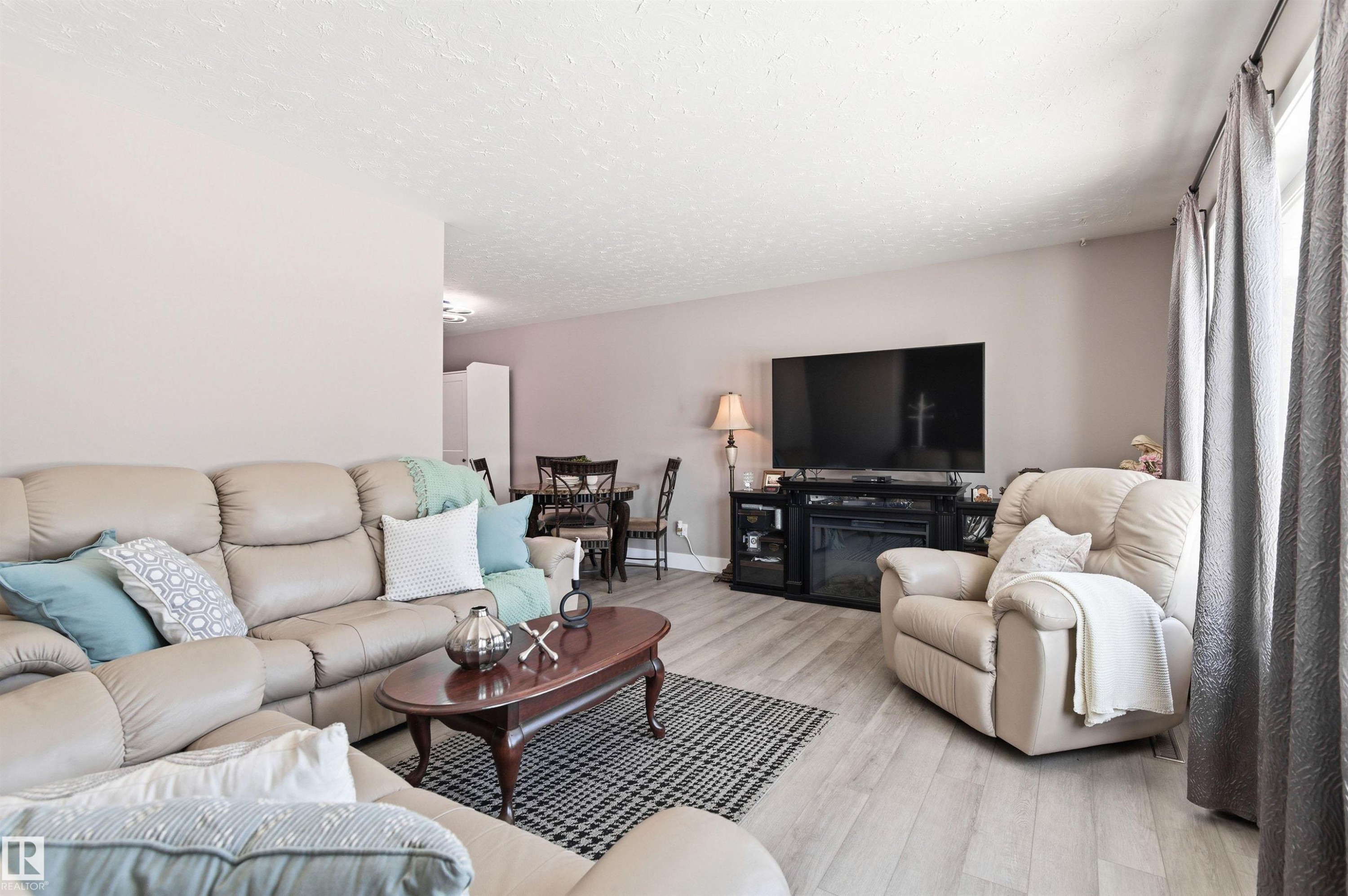 Living room with light-colored walls and light-toned flooring - 12904 95 Street, Edmonton, AB - Indoor Photo Showing Living Room