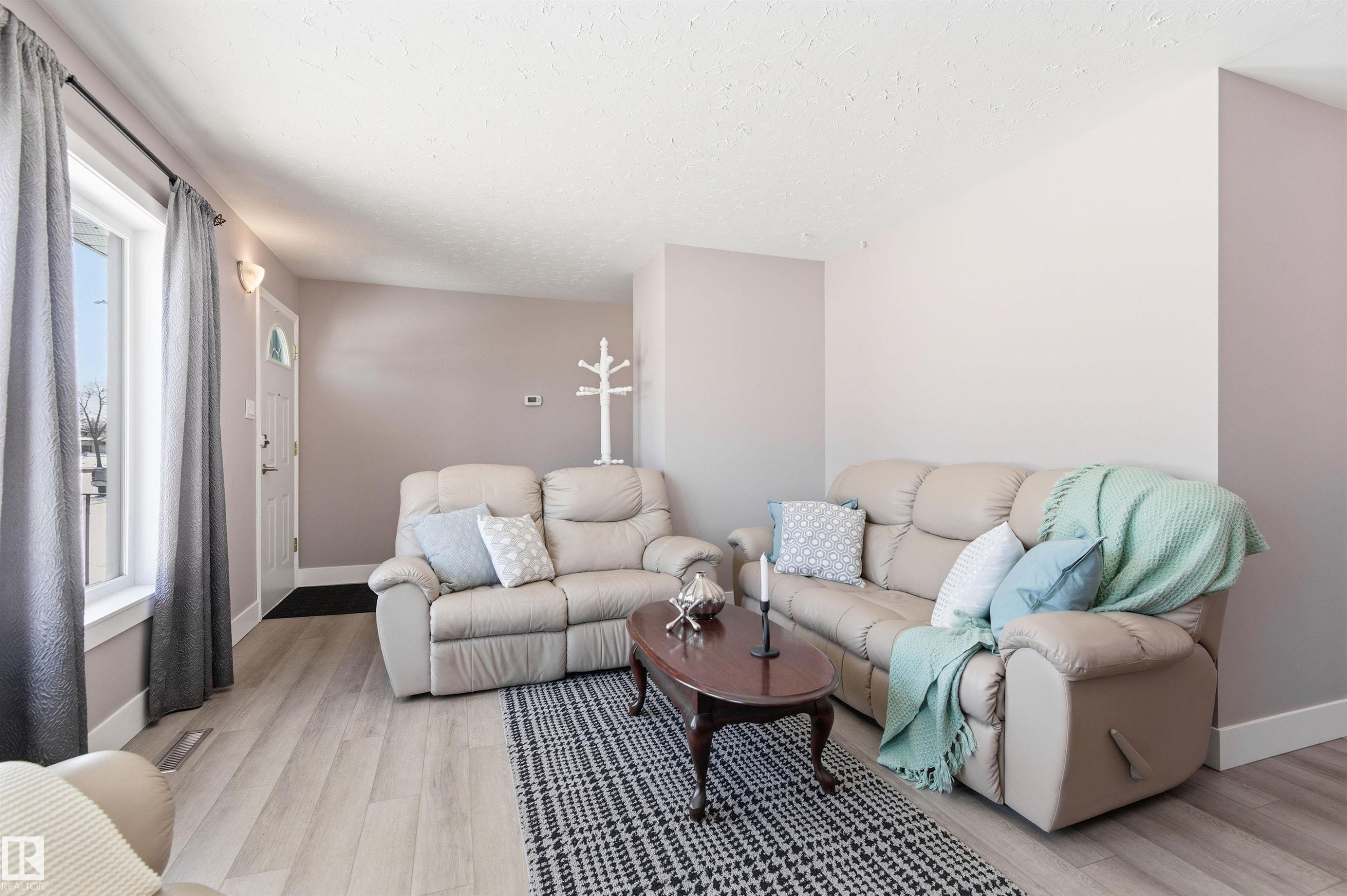 The living room features light-colored flooring and neutral-toned walls, creating a bright atmosphere - 12904 95 Street, Edmonton, AB - Indoor Photo Showing Living Room