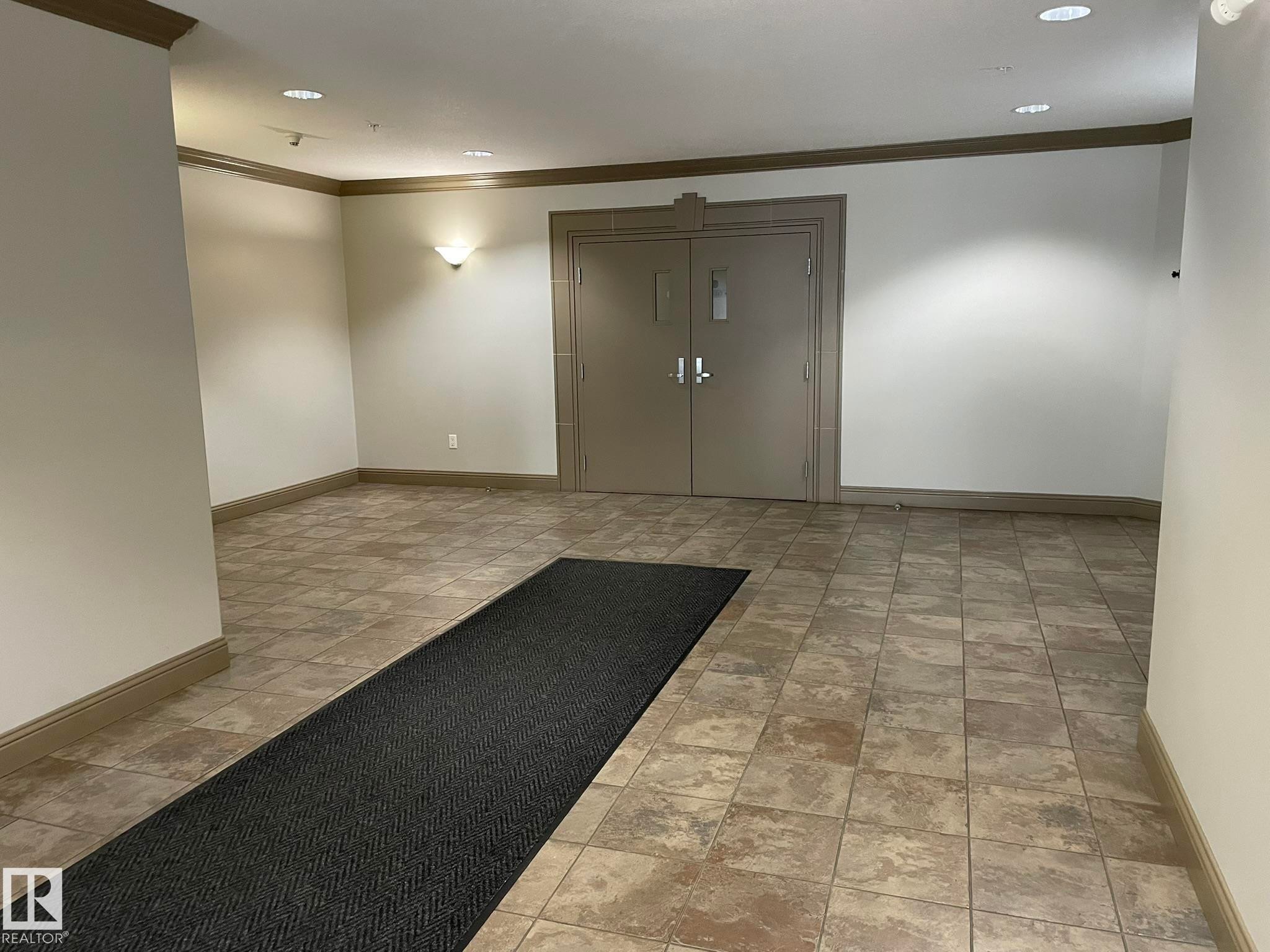 Entryway featuring neutral-toned floor tile and recessed lighting - Edmonton, AB - Indoor Photo Showing Other Room