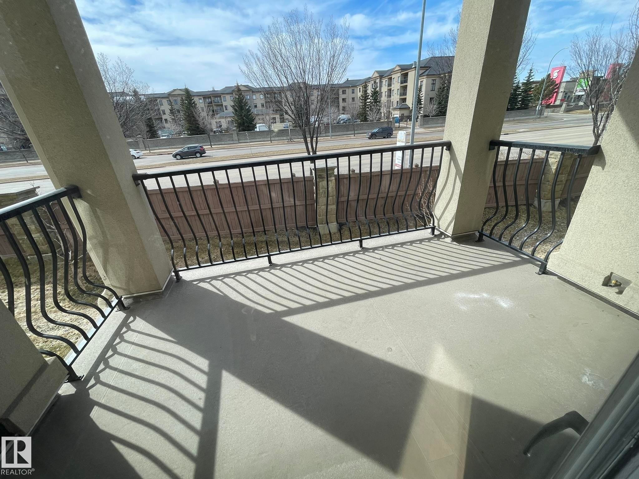 The property features a balcony with a concrete floor and a decorative metal railing - Edmonton, AB - Outdoor With Balcony