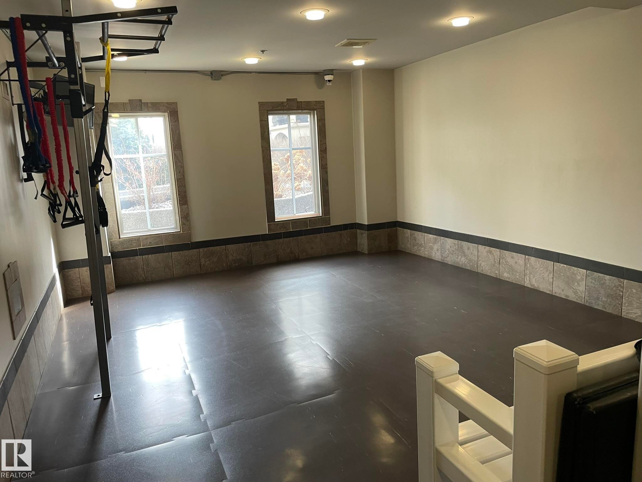 This versatile space features two windows, recessed lighting, and a durable flooring surface - Edmonton, AB - Indoor Photo Showing Other Room