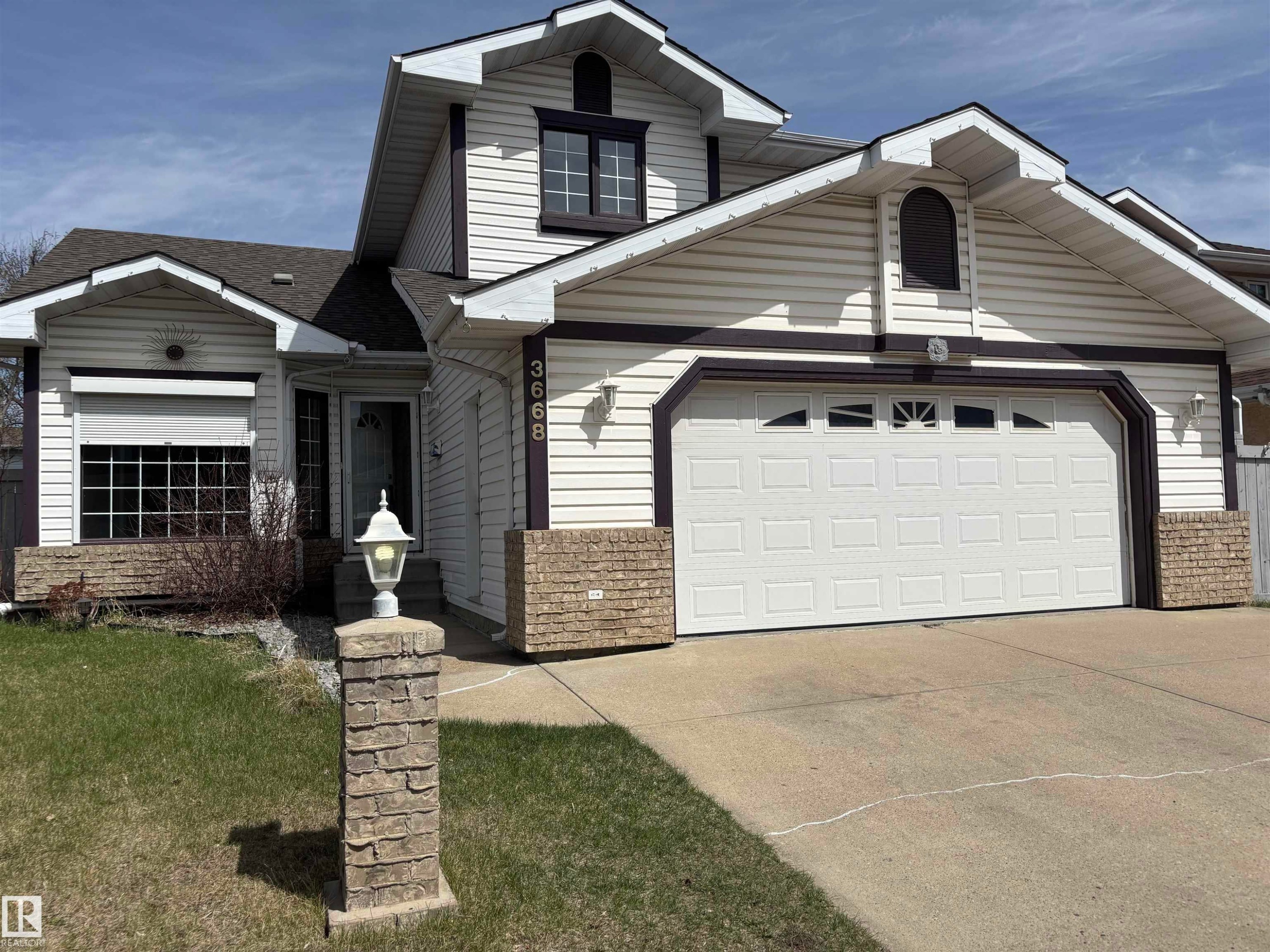 Two-story exterior with light-colored siding and dark trim accents - 3668 31A Street, Edmonton, AB - Outdoor