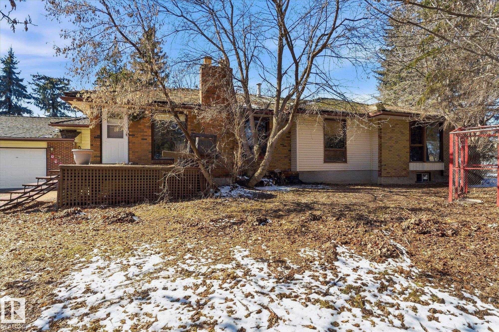 Brick and siding exterior featuring multiple window styles - 25750 18 Street, Edmonton, AB - Outdoor