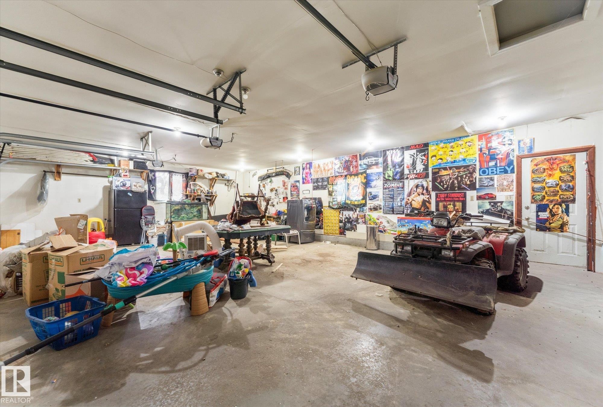 Spacious garage featuring a concrete floor, overhead garage door rails, recessed lighting, and a white painted ceiling - 25750 18 Street, Edmonton, AB - Indoor Photo Showing Garage