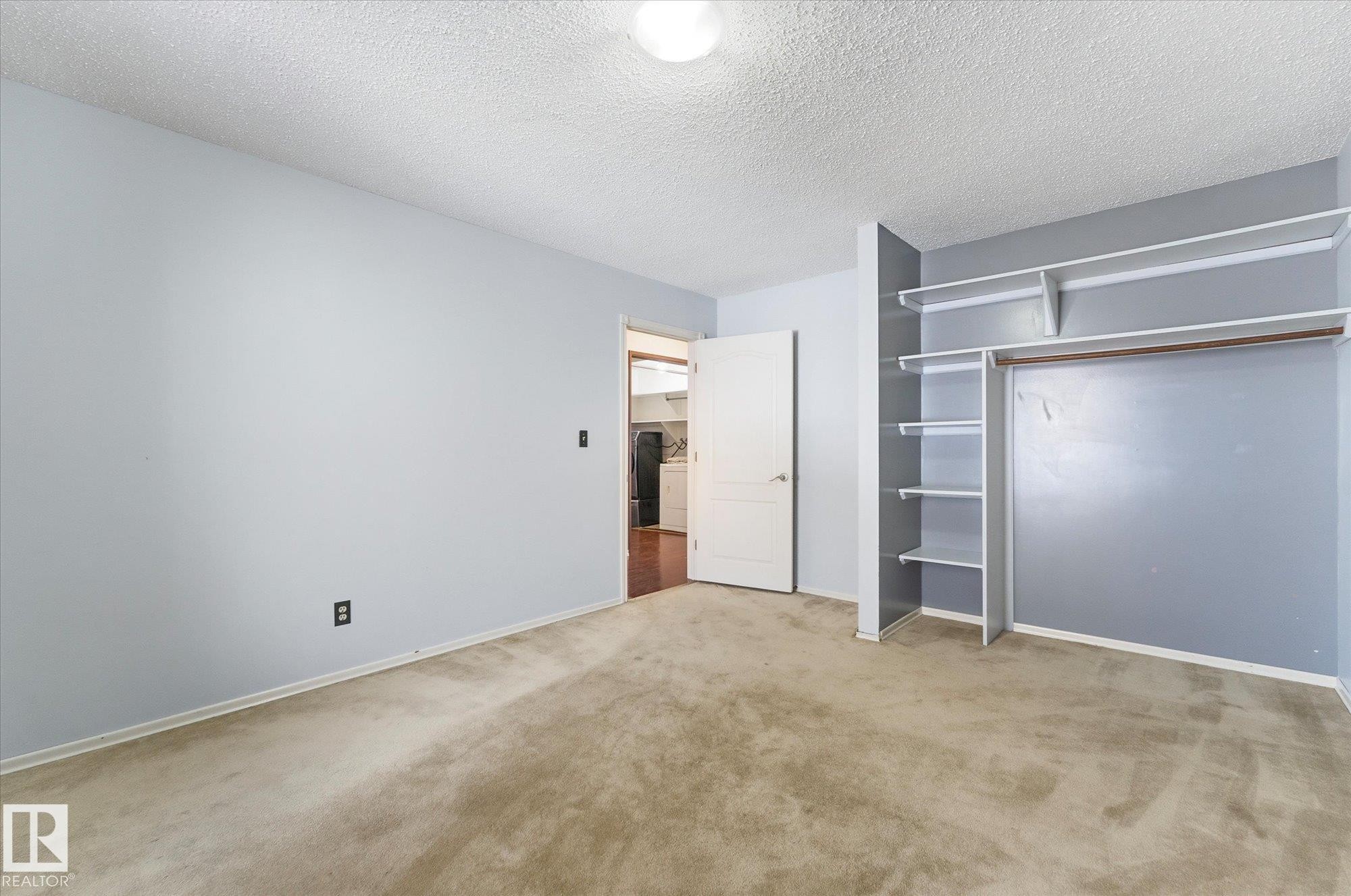 Room featuring light blue wall paint, textured ceiling, and neutral-toned carpeting - 25750 18 Street, Edmonton, AB - Indoor Photo Showing Other Room