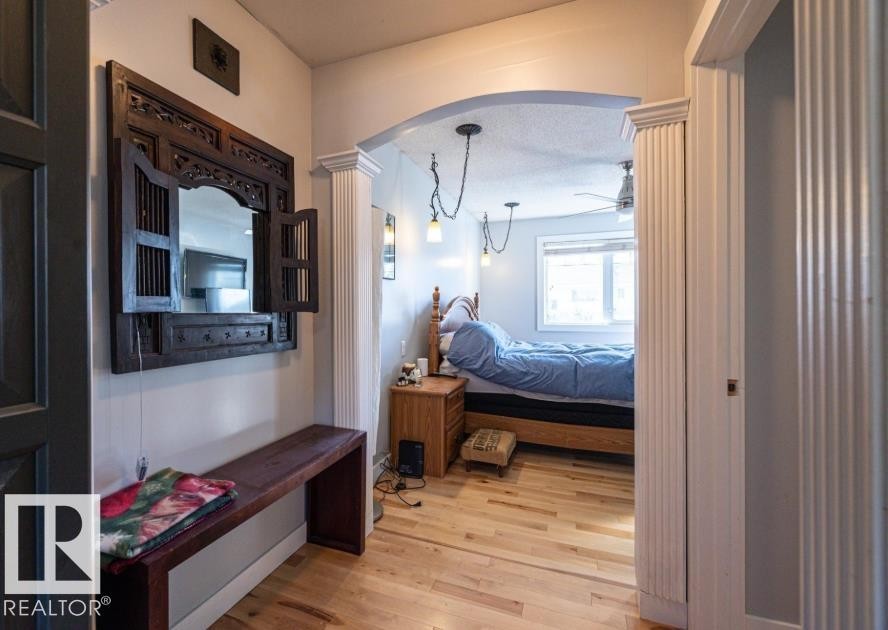 This property features hardwood floors and an arched entryway - 71 Labelle Crescent, St. Albert, AB - Indoor Photo Showing Bedroom