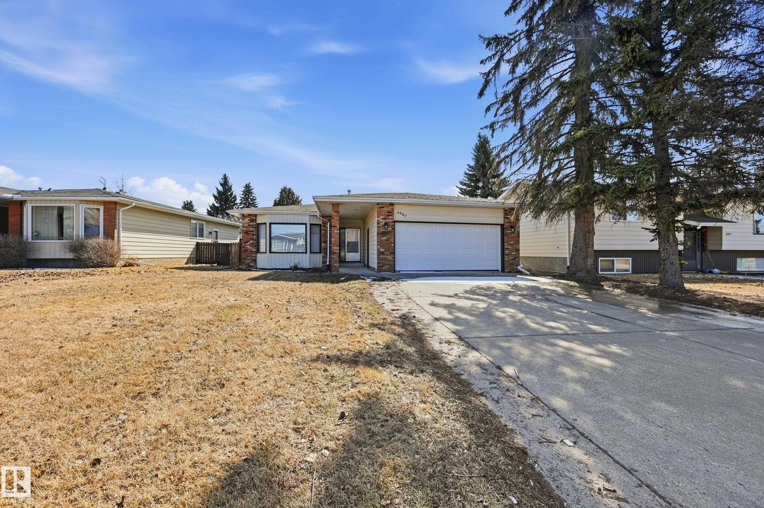 The property features a concrete driveway leading to an integrated garage - 6907 19 Avenue, Edmonton, AB - Outdoor With Facade
