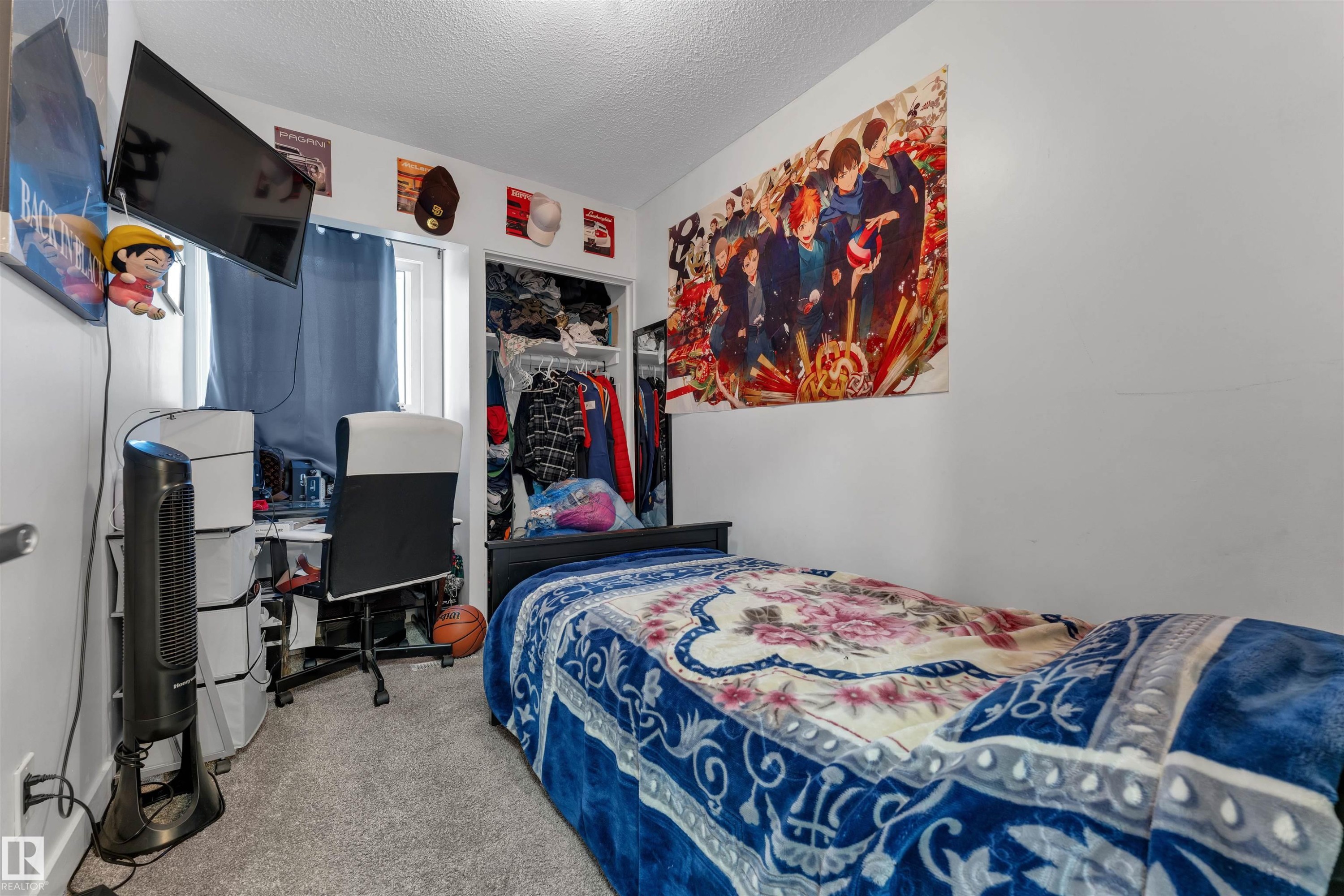 Bedroom featuring light gray wall paint, gray carpet flooring, a window with curtains, and a built-in closet with shelving and hanging space - 7 14115 82 Street, Edmonton, AB - Indoor Photo Showing Other Room