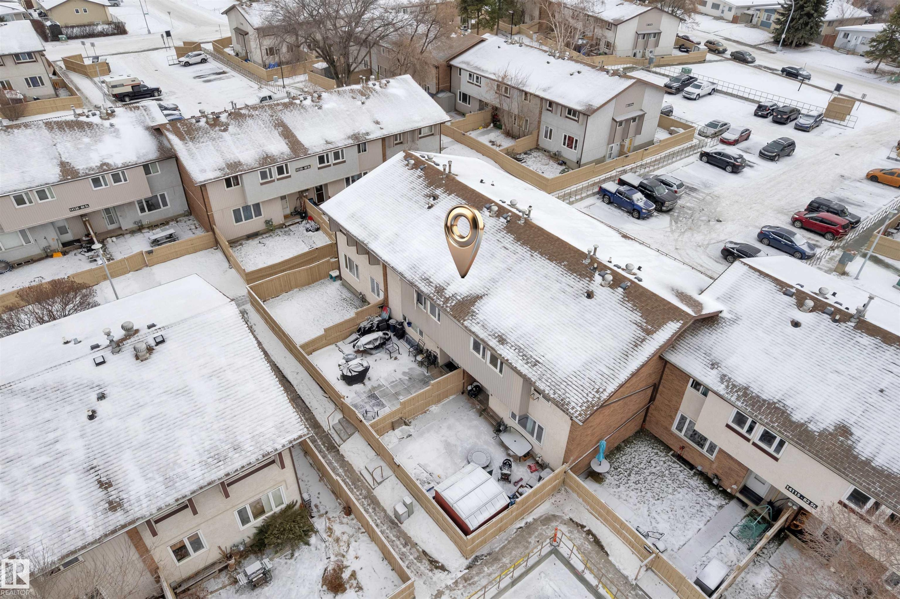 Townhome with a fenced backyard, shingled roof, light-colored siding, and a paved parking area - 7 14115 82 Street, Edmonton, AB - Outdoor With View