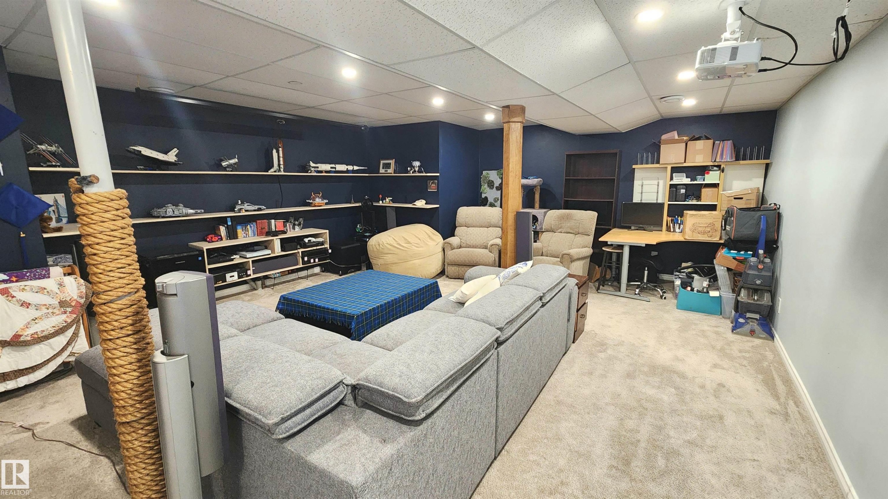 Finished lower level featuring recessed lighting, carpet flooring, a built-in media console, and an exposed wood structural column - 3531 46 Street, Edmonton, AB - Indoor