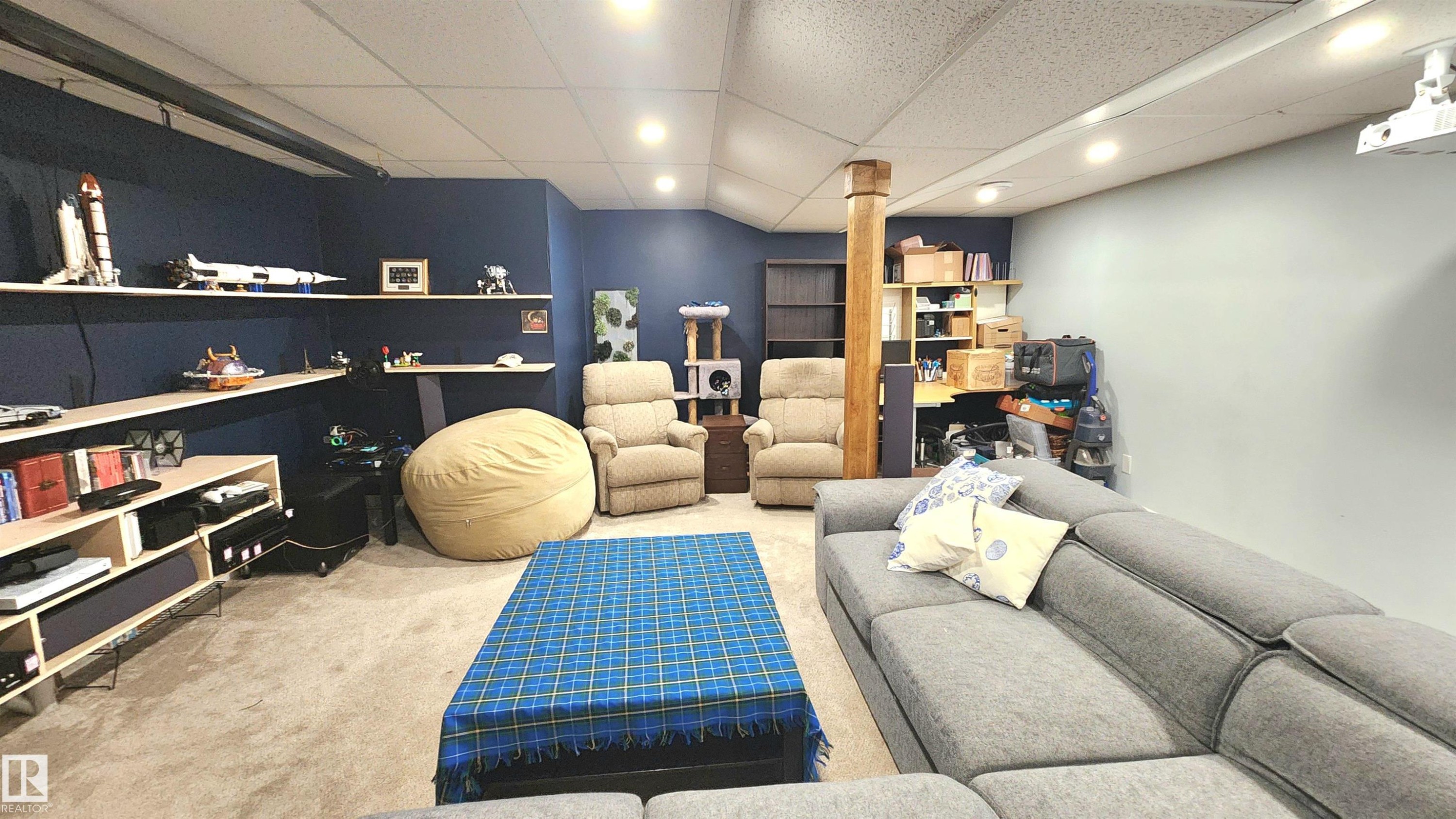 Spacious recreation room featuring recessed lighting, a carpeted floor, and a wood-wrapped support beam - 3531 46 Street, Edmonton, AB - Indoor