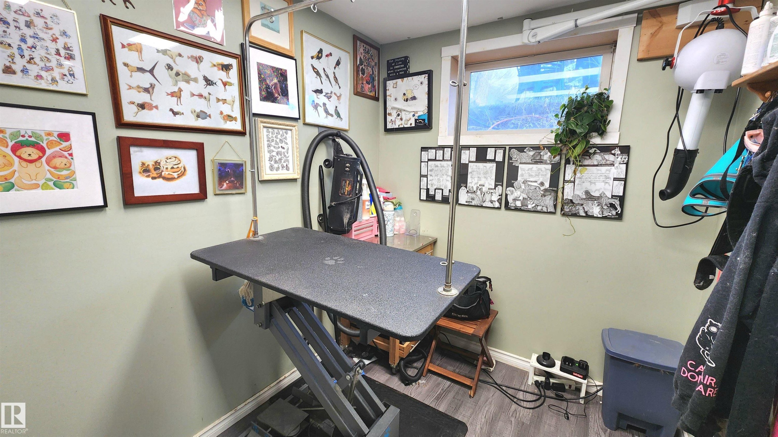 Specialized room featuring light green walls, a window, wood-finish flooring, and built-in shelving - 3531 46 Street, Edmonton, AB - Indoor Photo Showing Other Room
