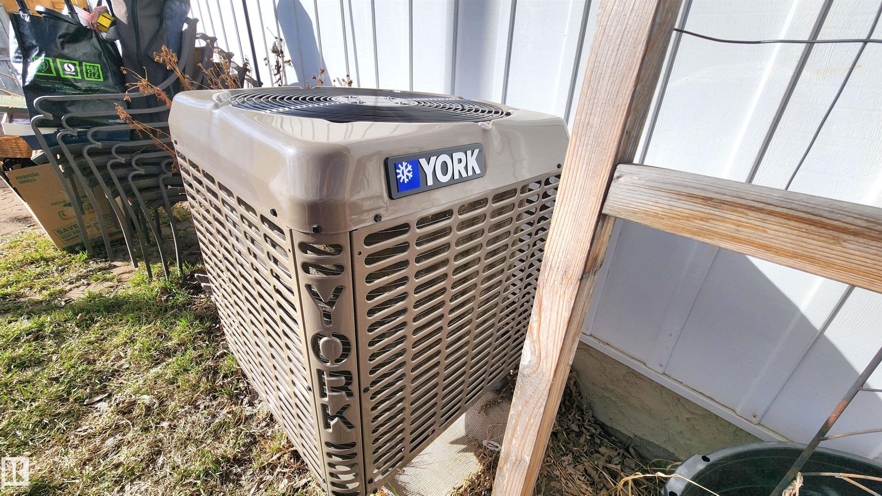 York brand HVAC unit on a concrete pad, situated beside white horizontal siding - 3531 46 Street, Edmonton, AB - Photo Showing Other Room