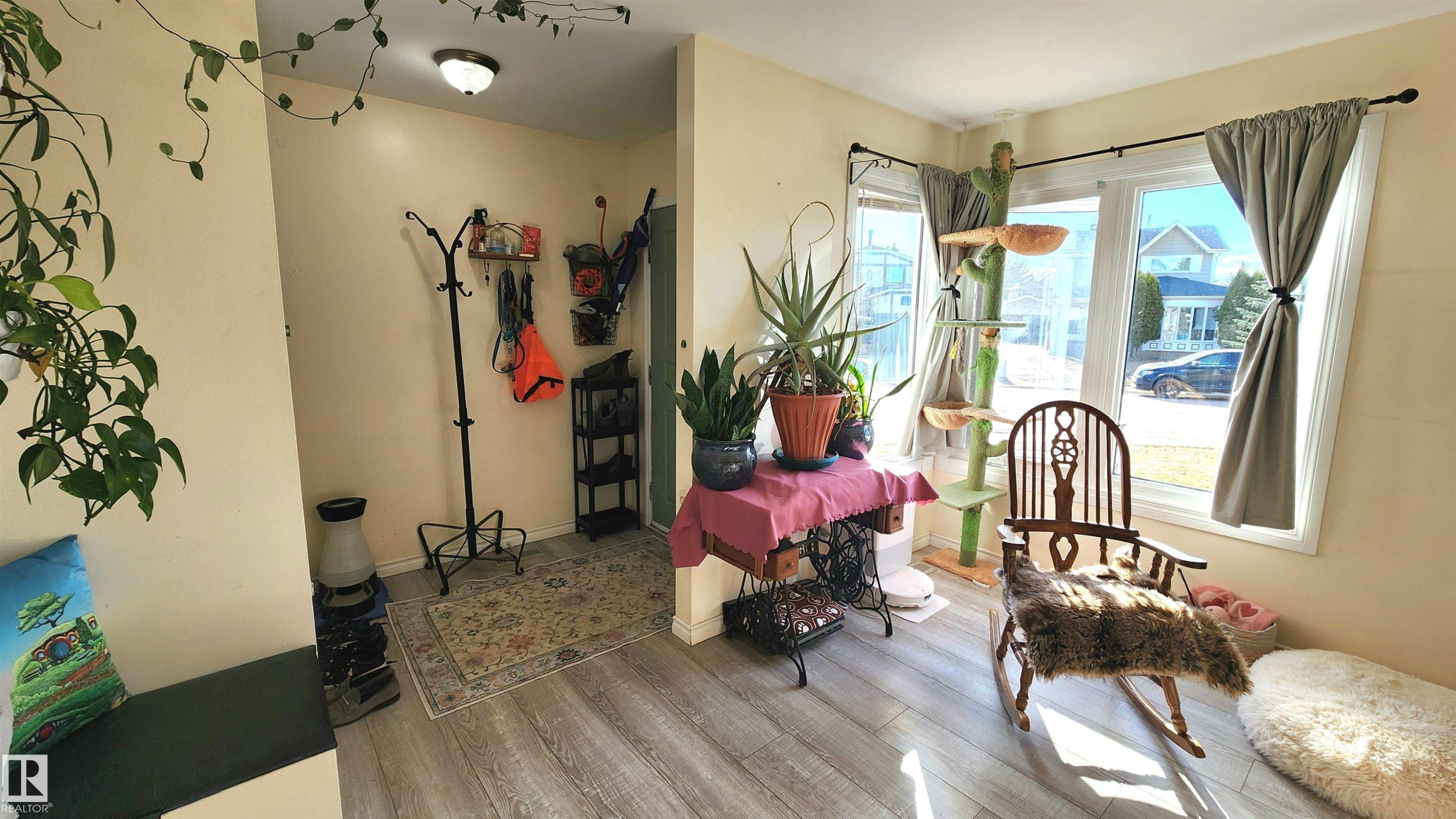 Entryway area featuring light wood-finish flooring, neutral wall paint, a built-in bench, and a flush-mount ceiling light fixture - 3531 46 Street, Edmonton, AB - Indoor Photo Showing Other Room