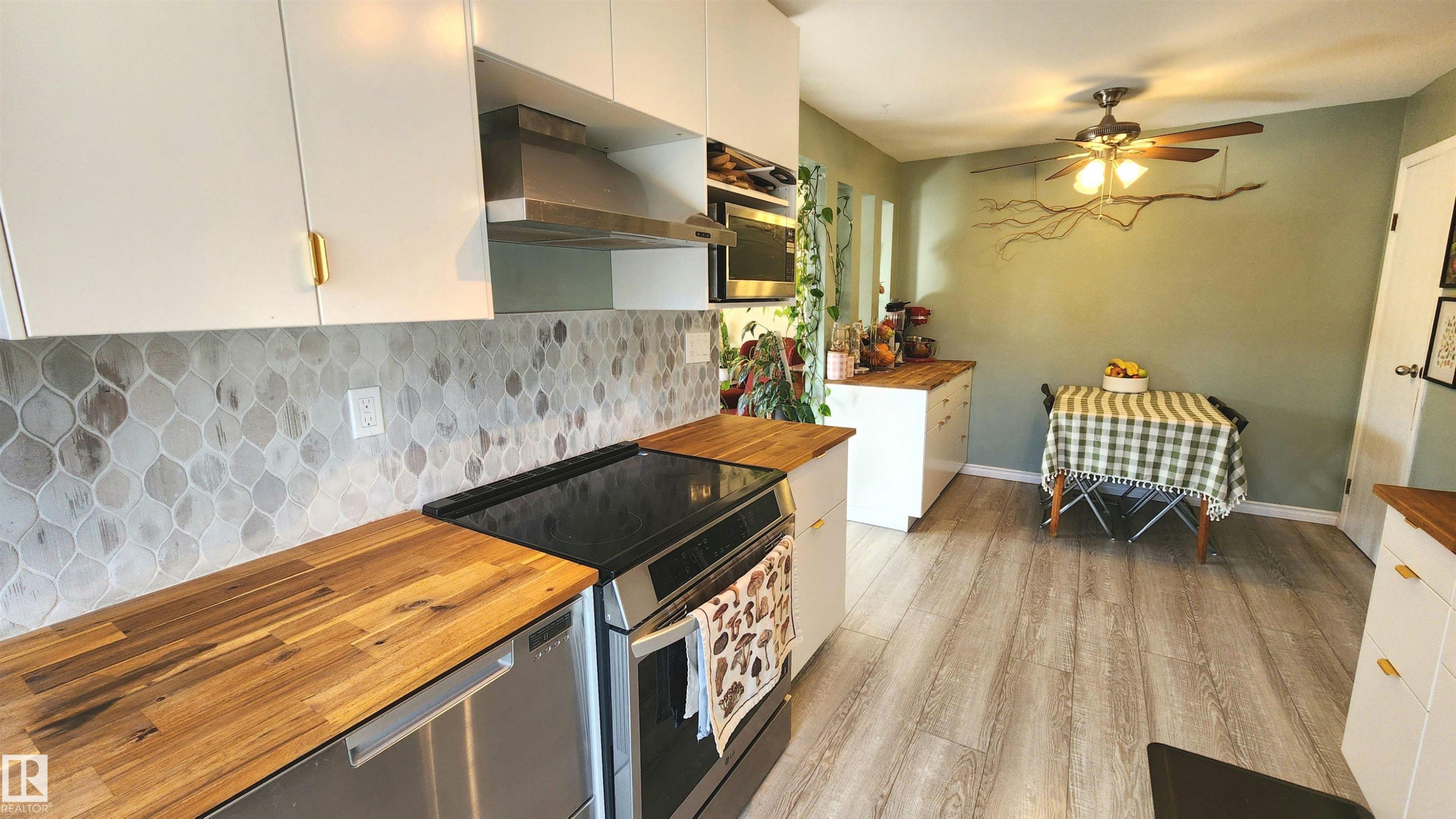 Kitchen featuring light wood-finish flooring and a ceiling fan - 3531 46 Street, Edmonton, AB - Indoor Photo Showing Kitchen