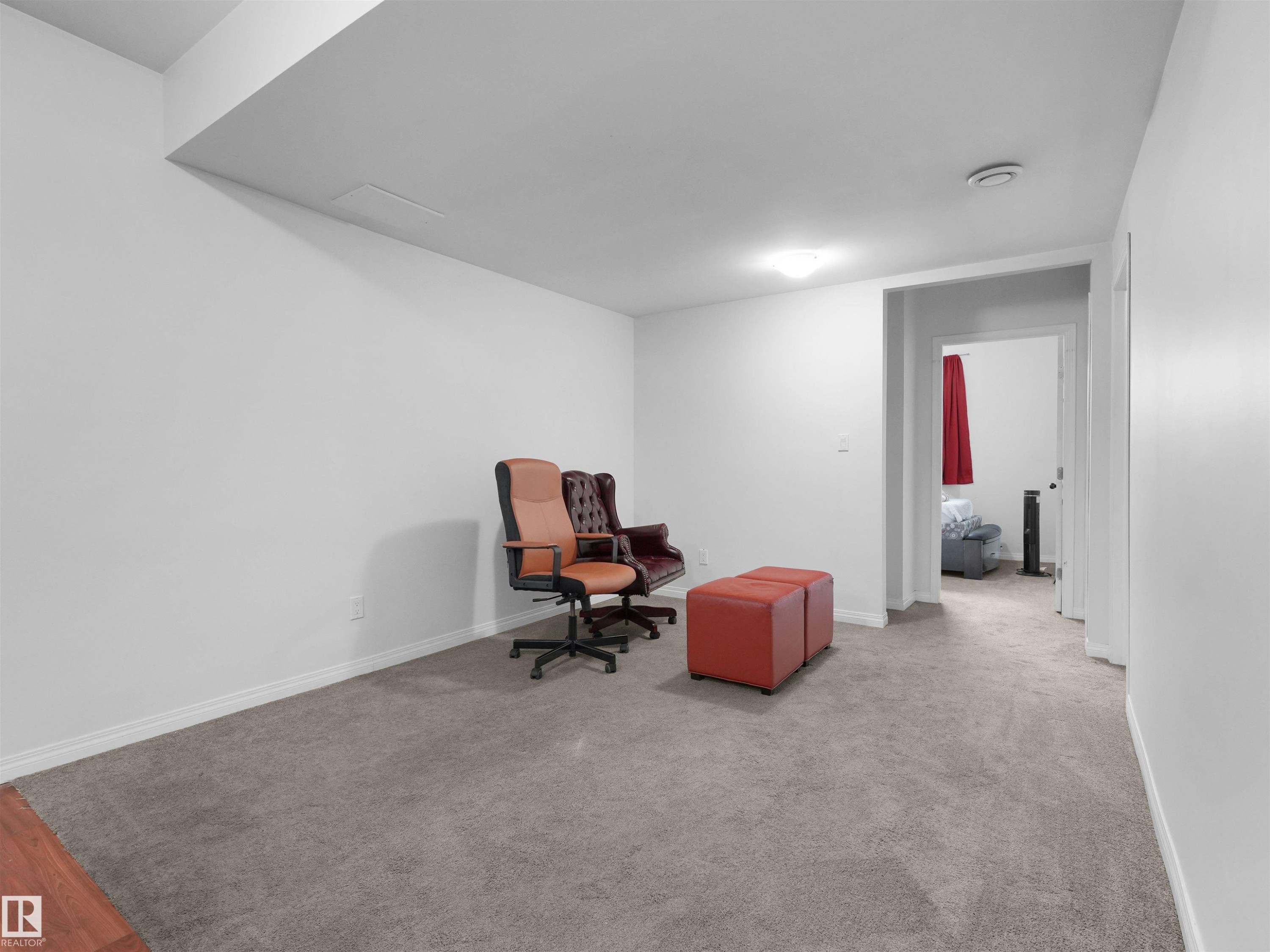 Carpeted room with white walls, baseboards, and a white ceiling - 5192 1B Avenue Sw, Edmonton, AB - Indoor Photo Showing Other Room