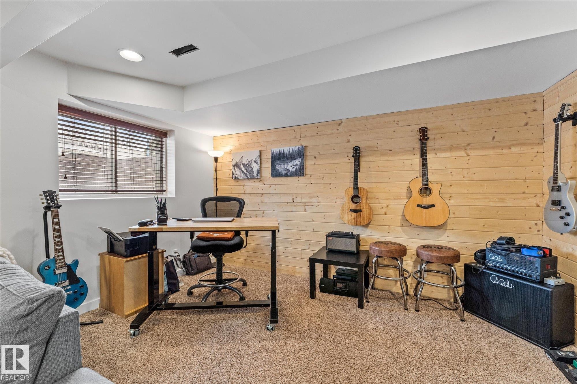 The property features an interior room with light-colored plank wood paneling on one wall - 3908 44 Avenue, Stony Plain, AB - Indoor