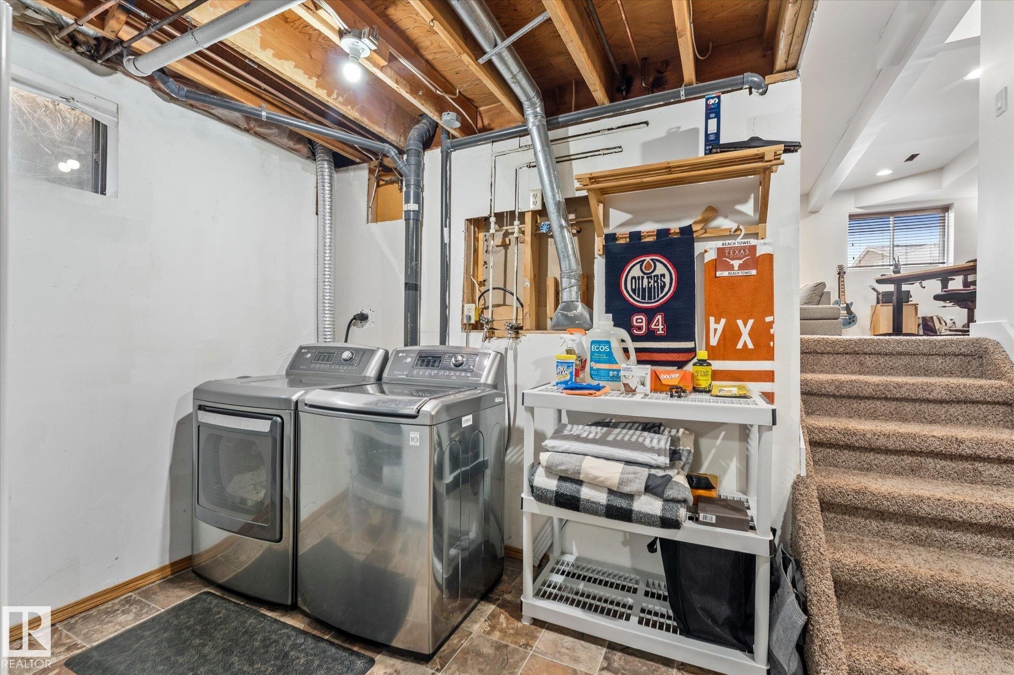 Dedicated laundry area with durable flooring and exposed ceiling beams - 3908 44 Avenue, Stony Plain, AB - Indoor Photo Showing Laundry Room