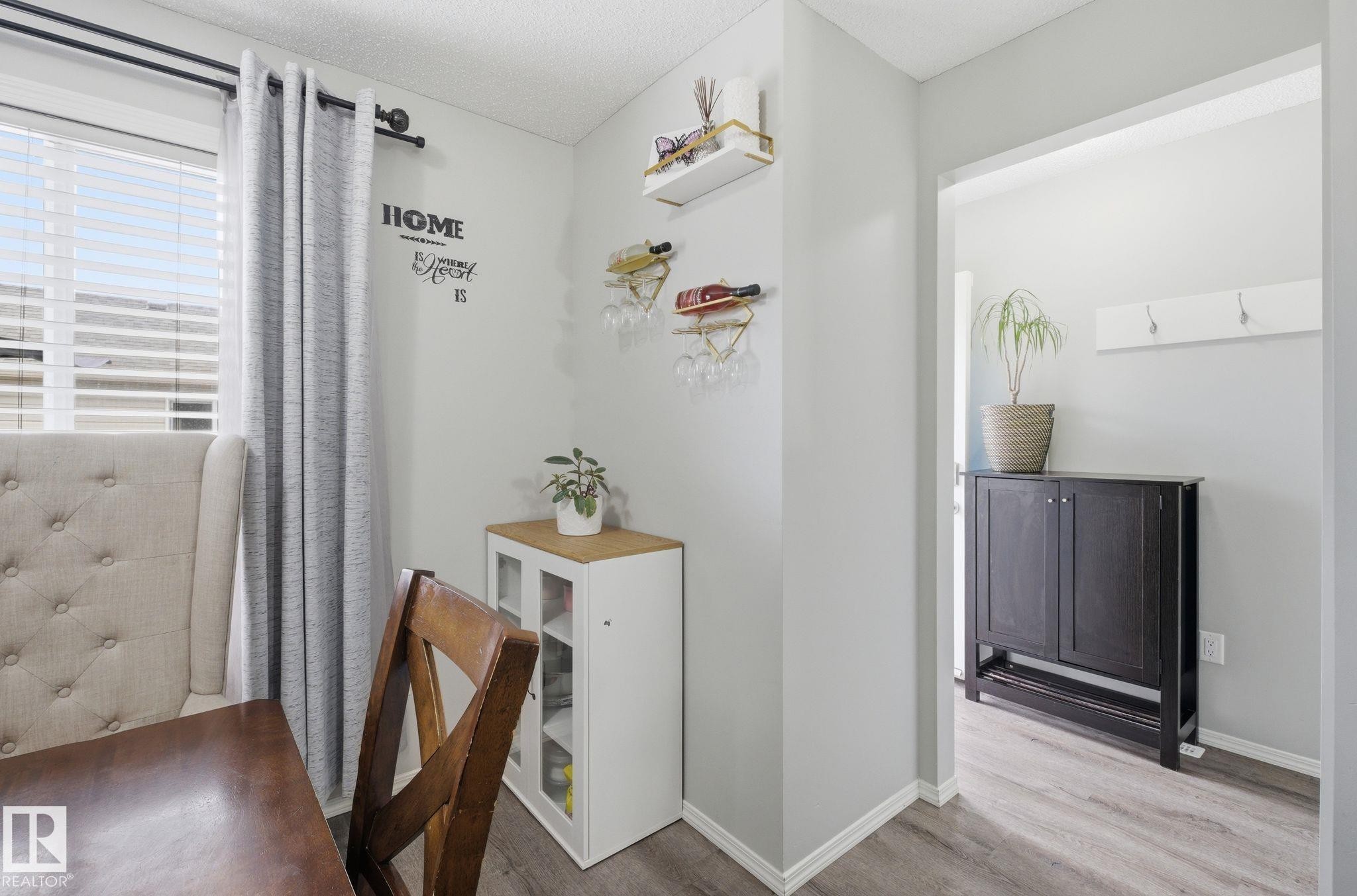 This bright interior space features light grey walls and durable flooring - 4636 175 Ave, Edmonton, AB - Indoor Photo Showing Other Room
