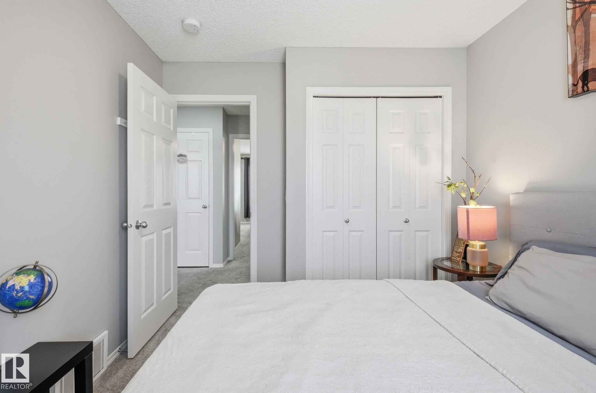 This room features light grey walls and light colored carpet, creating a neutral palette - 4636 175 Ave, Edmonton, AB - Indoor Photo Showing Bedroom