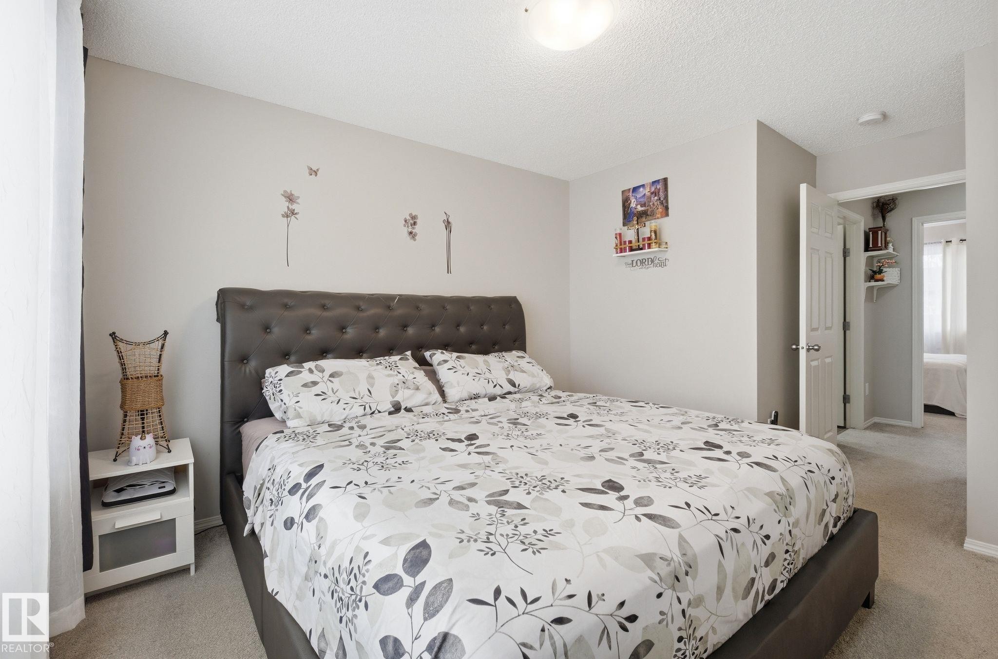 This bedroom features light-colored walls and plush carpeting - 4636 175 Ave, Edmonton, AB - Indoor Photo Showing Bedroom