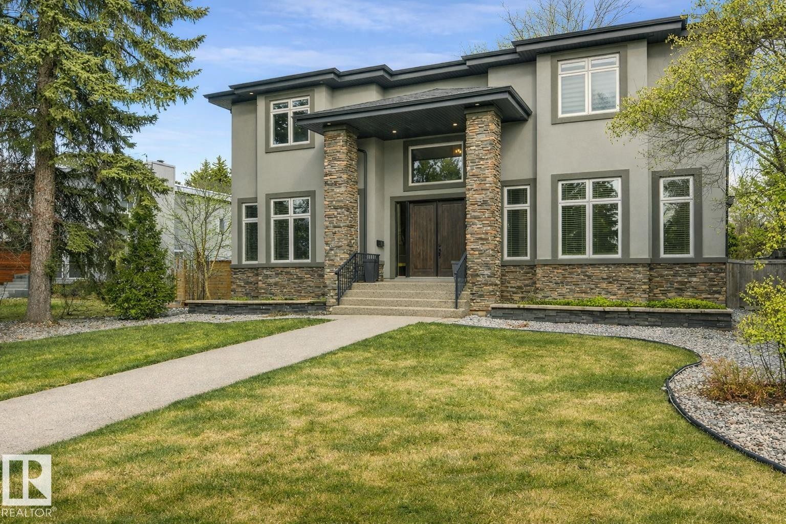 Contemporary exterior featuring a stone and stucco facade - 8927 120 Street Nw, Edmonton, AB - Outdoor With Facade