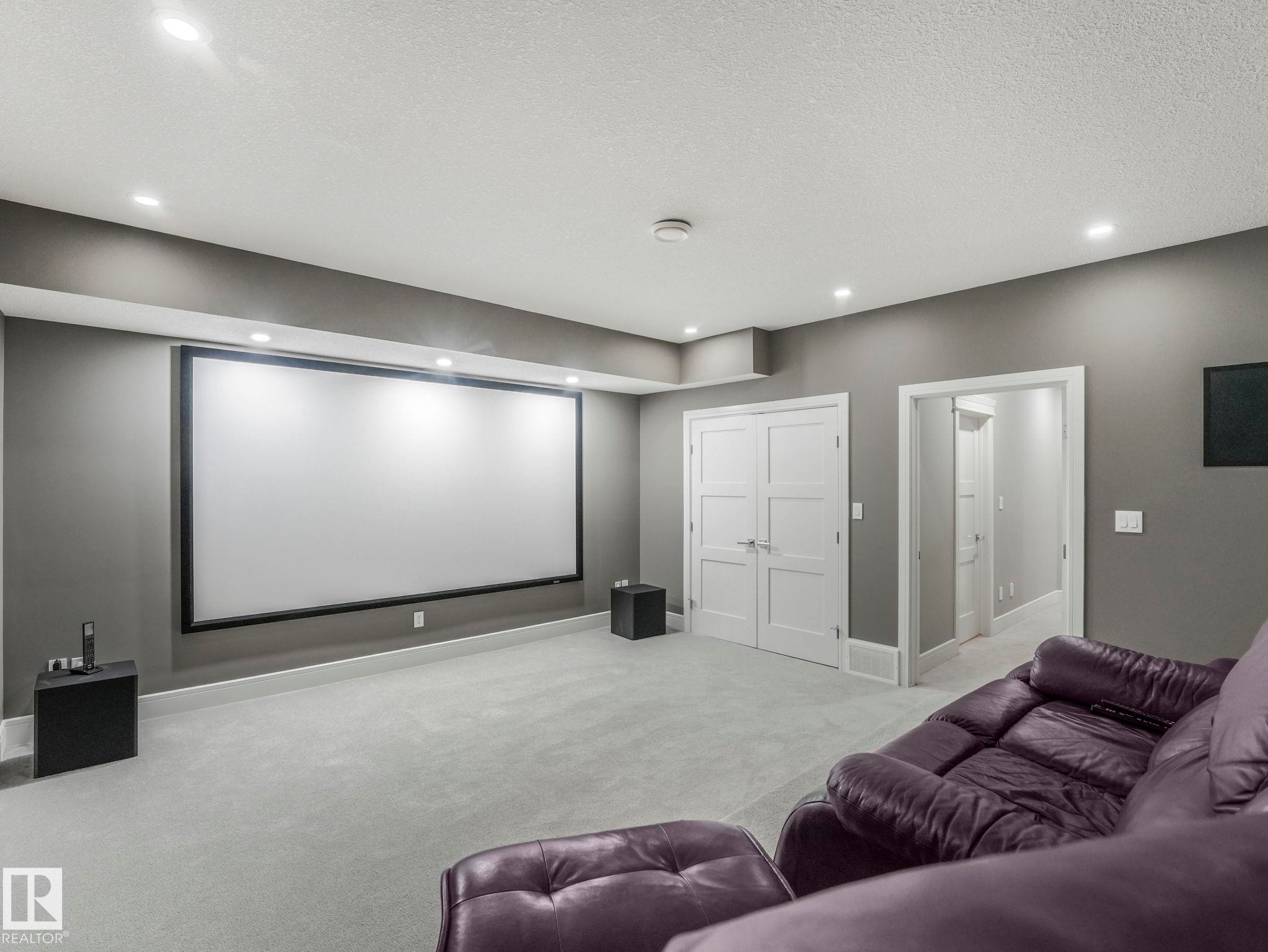 Sound proofed media room with high end projector and elevated seating platform. - 8927 120 Street Nw, Edmonton, AB - Indoor Photo Showing Other Room