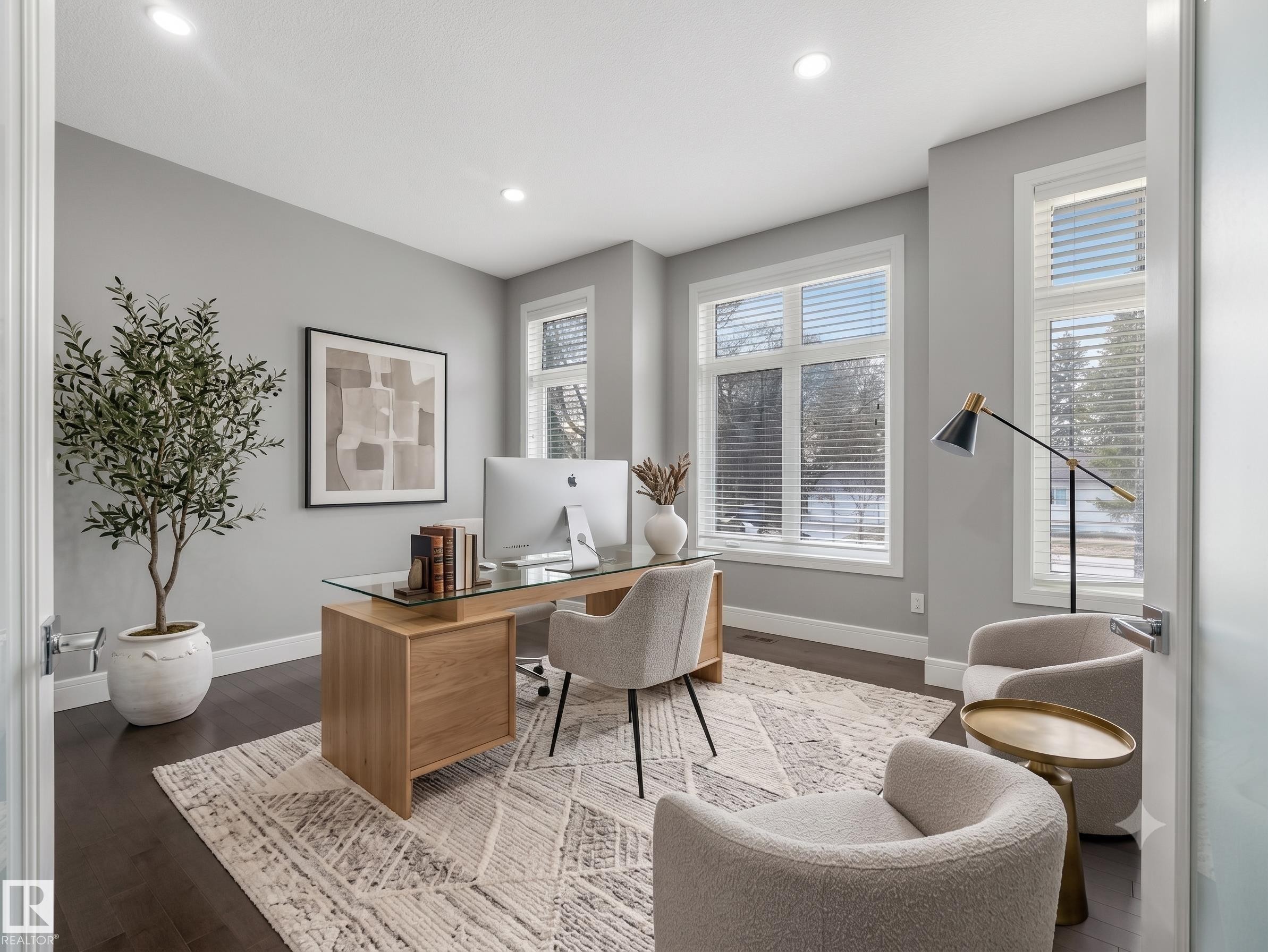Flex/den just off front entrance. Spacious interior room featuring dark wood-finish flooring, light grey painted walls, and abundant natural light from multiple large windows - 8927 120 Street Nw, Edmonton, AB - Indoor Photo Showing Office