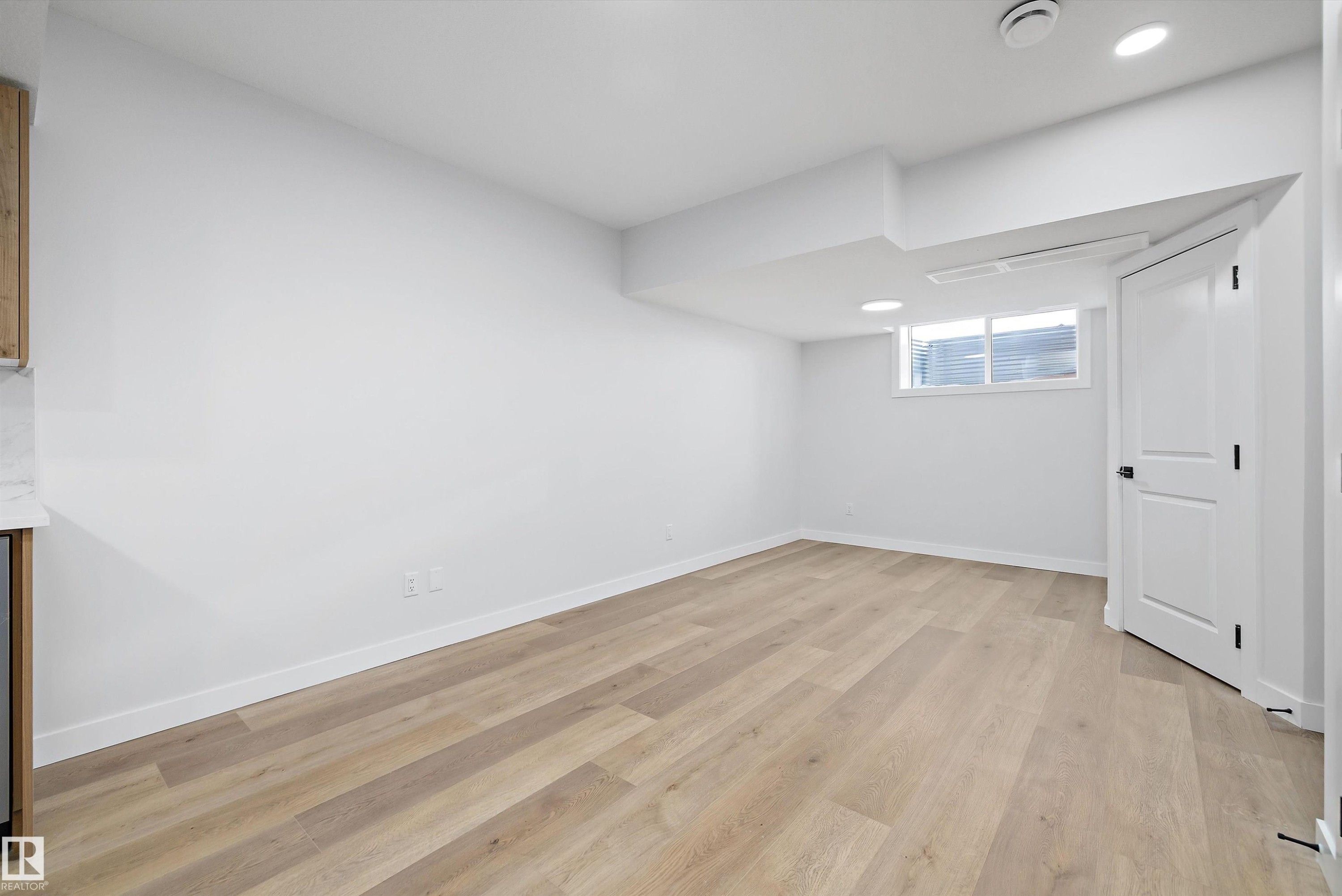 Open-concept room featuring wood-finish flooring, white walls, and recessed lighting - 954 Elderberry Landing, Edmonton, AB - Indoor Photo Showing Other Room